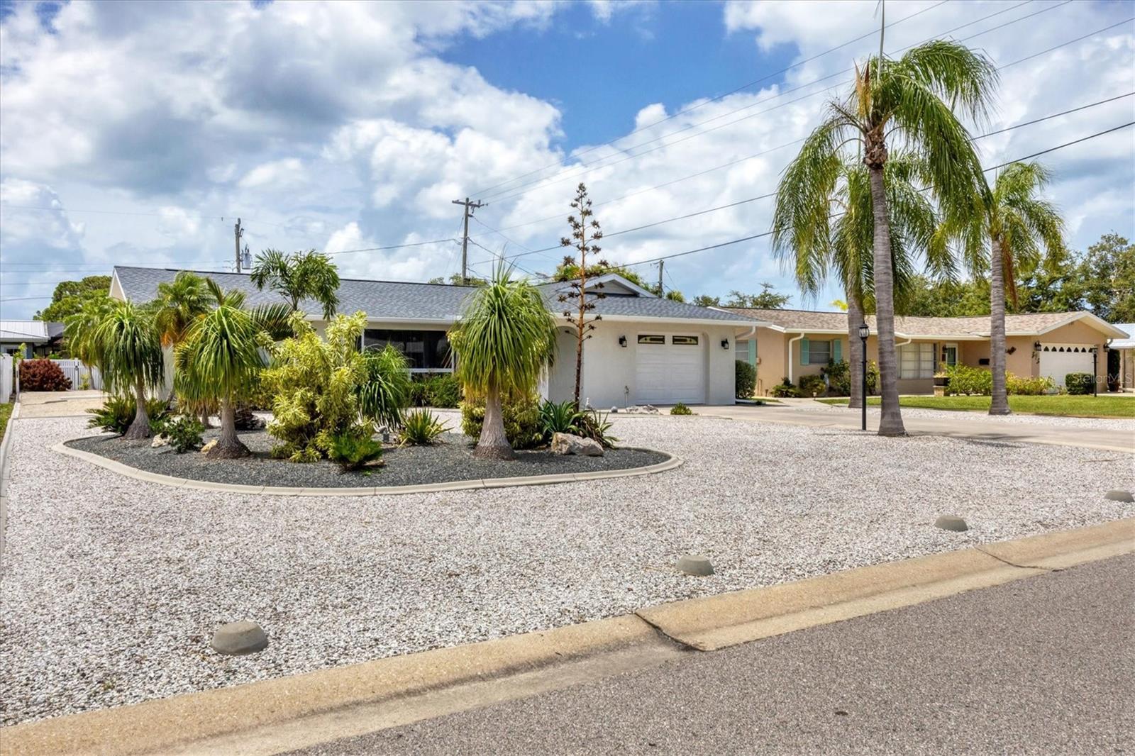 Welcome to this beautifully single-family home on Venice Island, where comfort meets coastal charm***The recently updated roof in 2023 ensures peace of mind, and its prime location offers proximity to the turquoise waters of the Gulf of Mexico and historic downtown Venice with its excellent restaurants, cafes, shopping and much more***This lovely home was extensively and tastefully renovated featuring spacious and bright bedrooms, a well-sized kitchen and a fabulous family room with sliding doors that open to the very large screened-in lanai perfect for entertaining***Park in the driveway and appreciate the clean look of the landscaped front yard laid out with shells for easy maintenance***Inside, discover a large casual living room with a cozy sitting area overlooking the front yard, providing a warm welcome to residents and guests alike***The split bedroom design ensures privacy for both guests and owners***Both suites are oversized. The primary bedroom features a comfortable en-suite bath and pocket doors that open to a walk-in closet***The two other guest bedroom has great space and a large closet***At the heart of this home is the perfectly sized kitchen with ample cabinetry with a sink and breakfast bar overlooking the spacious dining room. Whether having a coffee indoors or enjoying a book outdoors, the open sliding doors seamlessly connect the interior to the serene outdoor area***Embrace the coastal lifestyle in the thoughtfully designed lanai and backyard***To the right find a very private outdoor shower with hot and cold; just what you need after a day at the beach***A large shed with electricity and working bench, offers versatile space while the oversized under air one-car garage, equipped with a refrigerator, ample storage space, complements the property's functionality. This home has been meticulously maintained and loved***Pride in ownership and attention to detail is at the essence of this property***Located on a quiet street, you may ride your bike to the beach or walk downtown for shopping, a show in the Venice theater or fabulous eating in one of Venice's restaurants***HOME TO BE CONVEYED TURN KEY***
