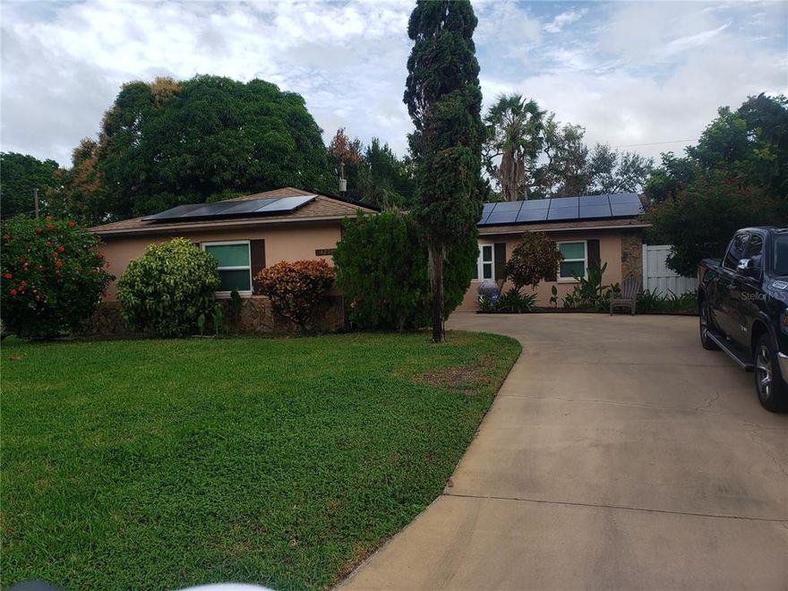 Tropical Fruit yard -3 bedroom, 2 bath 2 Car Garage curved driveway home on Coquina Key! As you walk through the front door, you will enter the inviting family room dining room area that opens up into the huge finished sunroom for expanded entertainment area.  Kitchen is equipped with dishwasher and stainless steel refrigerator and range.  Master bedroom and bath is isolated on one side of home and two additional bedrooms and bath on the other.  Vinyl fenced yard is adorned with tropical fruits (ackee, avocado, bananas and overhanging mango tree).  AC replaced within past three years.  Home equipped with solar power.