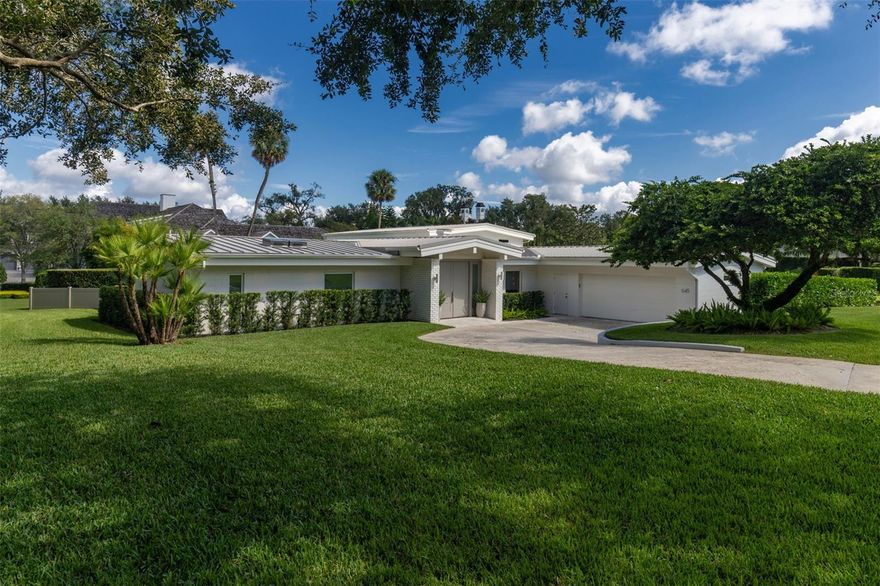 Welcome to your mid-century modern dream home! This stunning five-bedroom, five-and-a-half-bathroom residence spans almost 5,000 square feet across three levels, meticulously restored to highlight its architectural beauty. Nestled on nearly an acre of lush corner land in the sought-after Via’s, this property invites you to explore its open floor plan, featuring striking brick accents, original Terrazzo flooring, and vaulted tongue and groove ceilings throughout. Step into the inviting living room With a grand double sided fireplace shared with the beautiful dining room, which flows seamlessly into a gorgeous screened-in porch overlooking a sparkling 9-foot deep pool and expansive backyard. The completely renovated kitchen boasts French doors that open to a charming deck, perfect for enjoying the serene side yard with a natural gas fire pit and 20-foot tall bamboo, providing privacy and a lush backdrop.The lower level offers a spacious flex room that leads directly to the pool, along with a full bedroom and bath, plus an indoor storage area equipped with an extra refrigerator and wine fridge. On the upper level, you’ll find three generously sized bedrooms, each with its own walk-in closet and full bath. The main floor’s fully renovated primary suite is a true sanctuary, featuring stunning views and a luxurious shower illuminated by two skylights. Step outside to discover a backyard that opens to a walking path leading directly to the Winter Park Racquet Club, offering easy access to tennis, events, and lakeside dining. The expansive property provides ample space for a pool house, boat garage, or simply to relish the lush surroundings. With a brand-new roof, doors, windows, 4 a/c units and fresh interior and exterior paint completed in 2022, this extraordinary gem is ready for you to call it home. Don’t miss the opportunity to make it yours!