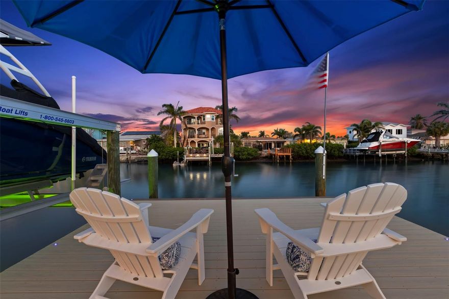 Discover the ultimate in luxury living with this newly remodeled waterfront home in Redington Shores, perfectly positioned near the point for spectacular views. Spanning over 3,500 sq ft, (4651SF under roof) this home is designed for multi-generational living with two primary suites. The first floor features an open great room with floor-to-ceiling windows, offering stunning views of the water and outdoor living space. The brand new modern coastal kitchen is a chef's dream with solid wood white cabinetry, a striking 10x6 ft island with seagull grey stain finish, exquisite stone countertops, and a matching wet bar for effortless entertaining. This floor also hosts a waterfront primary suite with a remodeled en-suite bath, plus two additional bedrooms and two remodeled bathrooms. The entire second level (over 1,000 SF) is a private retreat, showcasing an impressive primary suite with vaulted ceilings, a large custom walk-in closet, a morning kitchen, and a versatile space for a gym, office, or nursery. Enjoy expansive views from the expansive 400 SF+ covered deck and a rooftop viewing area accessed by a spiral staircase, perfect for sunsets and fireworks. The outdoor area is designed for relaxation and entertainment, featuring a beautiful pool, brick pavers, a covered gazebo, an 18x30 composite dock, and a 10,000 lb boat lift. Inside, enjoy designer touches such as large format porcelain tile throughout the first floor, a cathedral foyer, and a stylish staircase with glass railings and hand-painted risers. The home also includes a glazed tile roof, 2 tankless hot water tanks,  and an oversized temperature-controlled 1 car garage with a half bath, laundry, and ample storage, plus an expanded paver driveway accommodating three cars. This residence offers elegant design, functionality, and stunning waterfront living perfect to meet the needs for today's modern lifestyle!