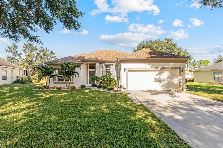 Welcome Home to Johns Landing! Discover this beautifully maintained 4-bedroom, 2-bath residence located in the gated community of Johns Landing, offering private boat access to scenic Johns Lake. From the moment you step into the foyer, you’ll appreciate the soaring volume ceilings, tile flooring throughout the main living areas, and an abundance of natural light that creates a bright and inviting atmosphere. To the left, a spacious living and dining room combination provides an ideal setting for entertaining and offers convenient access to the kitchen. The kitchen is well-appointed with solid wood cabinetry, granite countertops, stylish backsplash, a breakfast bar, and stainless steel appliances. The kitchen opens to a generous living area featuring sliding glass doors that lead to a large paver patio with fruit trees—perfect for indoor-outdoor living and relaxing gatherings. The primary suite is thoughtfully tucked down the hallway and showcases engineered hardwood flooring, a walk-in closet, and a beautifully renovated en-suite bath. The primary bath features a standalone shower, garden tub, and dual vanities. Three additional bedrooms, a guest bathroom, and a laundry room complete the interior layout. Residents of Johns Landing enjoy resort-style amenities including basketball, tennis, and pickleball courts, a playground, an open dock with private boat ramp, and a gazebo. Upgrades include: Water Heater (2024), Roof (2018), Double Pane Windows and New Slider (2024).  Conveniently located near downtown Winter Garden, downtown Clermont, downtown Oakland, and major highways, this home offers both tranquility and accessibility. Don’t miss the opportunity to enjoy lake-access living in this desirable community!