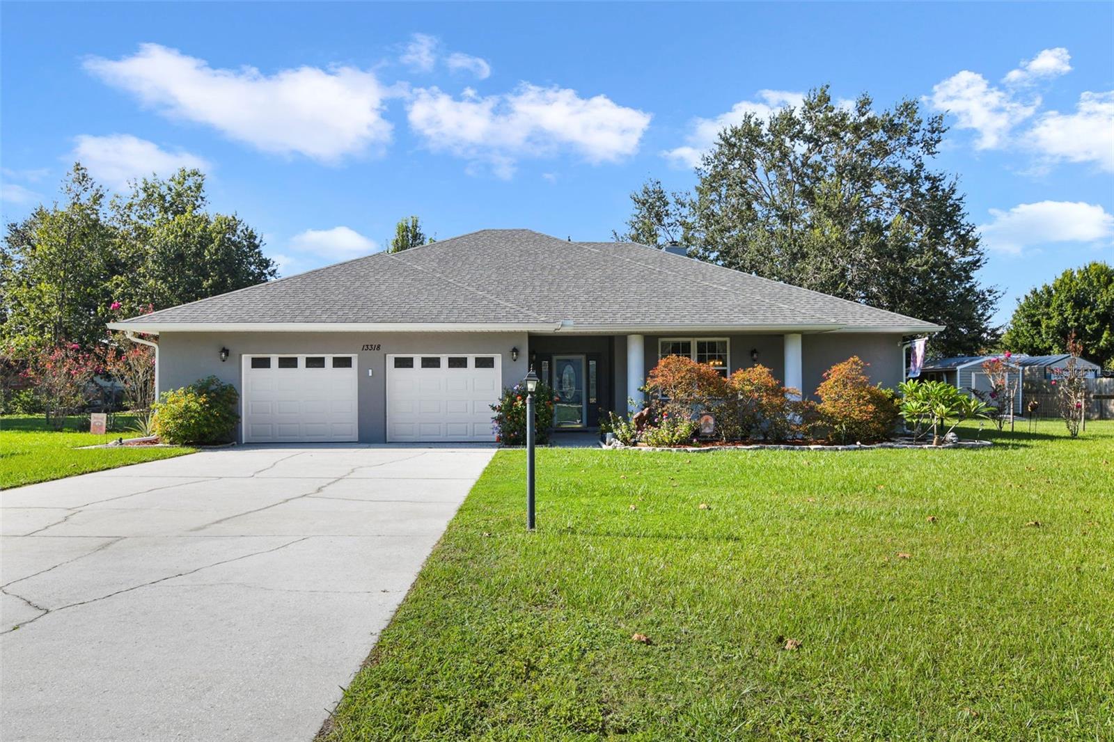 Welcome Home - No HOA and Less Than a Mile from Little Lake Harris boat ramp on the Harris Chain of Lakes!
This charming residence offers a fully fenced backyard with meticulously maintained landscaping. The inviting front door, adorned with decorative glass and sidelights. Inside, a spacious tiled foyer leads to a bright living room with soaring ceilings, wood-look tile flooring, and a stunning rock fireplace—perfect for cozy evenings. The expansive kitchen features high-end Samsung stainless steel appliances, abundant upgraded cabinets, and a welcoming eat-in area. The oversized master suite provides ample room for a home office and boasts a massive walk-in closet. The master bath includes brushed nickel fixtures, a large walk-in shower, and a relaxing soaking tub—perfect for unwinding after a long day. On the opposite side of the home, a guest area offers two sizable rooms, each with deep closets for ample storage and guest privacy. The guest bathroom features a generous soaking tub. Additional highlights include double-pane windows and a water heater updated in 2024. The roof was replaced in 2022, and the HVAC system was updated in 2020, ensuring years of reliable comfort. The expanded two-car garage offers space for a workshop and includes a pull-down attic for extra storage. Outside, enjoy the screened patio and a shed ideal for lawn equipment, along with an overhang perfect for storing a camper or boat.This fantastic home combines comfort, privacy, and easy access to Little Lake Harris—schedule your showing today!