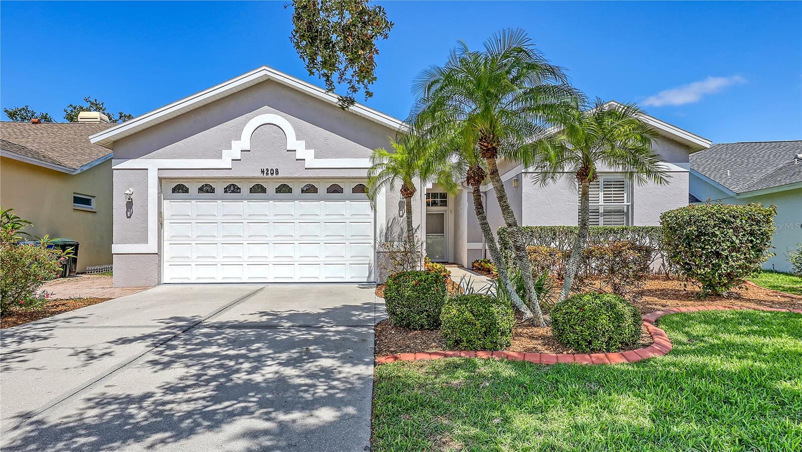 This bright and beautiful 3 bedroom, 2 1/2 bath home is exceptionally well maintained, tastefully updated, and turnkey furnished (buyer's option). The 2187 square foot main living area features high ceilings and tall windows throughout, and plantation shutters filter the sunlight in every room. As you enter the home, a large foyer leads directly to the living and dining room. These rooms provide a comfortable space for formal entertaining, and the cathedral ceiling makes them feel especially spacious. In the recently renovated kitchen, rows of tall cabinets meet nearly 20 linear feet of superior grade granite counter tops. Open the doors, pull out the drawers and the shelves in the lower cabinets, and imagine how you will use this great space. The adjoining dinette and family room have a casual feel, and both rooms overlook the lanai and private back yard. The enclosed, air conditioned lanai offers 237 additional square feet of versatile year round living space - perfect for an office, an art studio, a gym, or just a space to open the windows and bring the outdoors in. Moving to the bedrooms, the primary suite includes a large en suite bath with dual sinks and a gorgeous new granite counter top. Two additional bedrooms are on the opposite side of the home, nicely separated from the main living area. A guest bathroom and half bath are nearby. Significant upgrades to this home include a newer roof (2020), HVAC system (2021), granite counter tops in the kitchen and bathrooms, those exceptional kitchen cabinets, and Pella windows on the lanai. For many buyers, the most appealing feature is that this home does not have a pool. Save the expense, the time, and the maintenance, and simply cross your private back yard and through the hedge to the adjoining park and community pool. Country club membership is not included with the purchase of this home, but Stoneybrook Golf And Country Club is semi-private and non-members may dine at the clubhouse and have limited golf access. Don't miss this home - see it today!