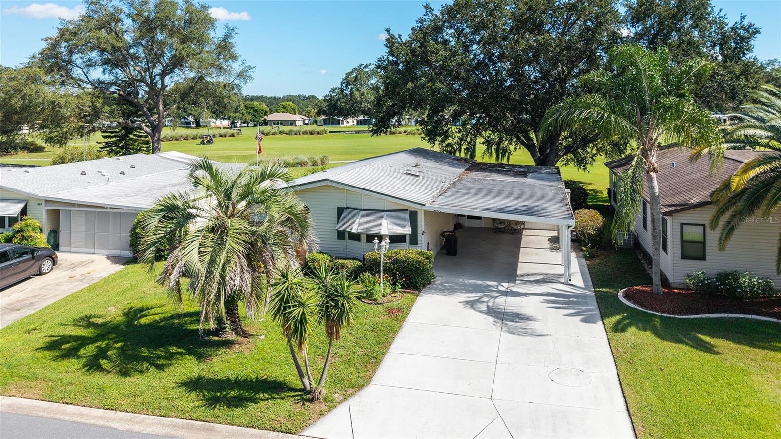 No Bond! Don’t miss this 2-bedroom, 2-bath manufactured home perfectly positioned on the scenic Silver Lake Golf Course.
From the moment you arrive, you’ll be welcomed by a charming palm tree and a spacious, covered driveway with room for two vehicles. The oversized carport offers plenty of shade, and the golf cart garage provides excellent extra storage—complete with a refrigerator, washer, and dryer.
Step into the covered and screened-in lanai, where you'll enjoy peaceful mornings and relaxing evenings overlooking the tranquil beauty of Silver Lake Golf Course. With its majestic oak trees and gentle rolling hills, the view is nothing short of picturesque. Whether you're sipping coffee at sunrise or entertaining guests, this home offers a relaxing retreat in a serene golf course setting.
Step inside to an open floor plan with high ceilings and an inviting, light-filled atmosphere. The spacious kitchen offers stylish backsplash, an open-concept design with upgraded lighting fixtures, seamlessly connecting to the oversized living area—perfect for relaxing or entertaining.Enjoy serene golf course views from the stunning Florida room, complete with a built-in bar ideal for hosting guests. A lighted built-in cabinet in dining area adds both charm and extra storage space.The versatile second bedroom includes a built-in Murphy bed, office counters, a ceiling fan with light, and spacious walk-in closet—making it perfect for guests or a home office setup.
Retreat to the primary suite, which features an upgraded ceiling fan and lighting, a large walk-in closet, and a spacious en-suite bath. The primary bathroom offers a walk-in tiled shower, a linen closet, and additional storage. Additional features, new kitchen sink, HVAC 2023 and home has a metal roof. This home combines comfort, function, and picturesque views for the perfect Florida lifestyle. Ideally located just steps from the Silver Lake Recreation Center and conveniently close to restaurants, shopping along 441, and the vibrant Spanish Springs Town Square, offering even more dining, shopping, and entertainment options. You're also just a short ride from the Hilltop Adult Pool and the Orange Blossom Hills Country Club, featuring a beautiful resort-style pool and golf course.