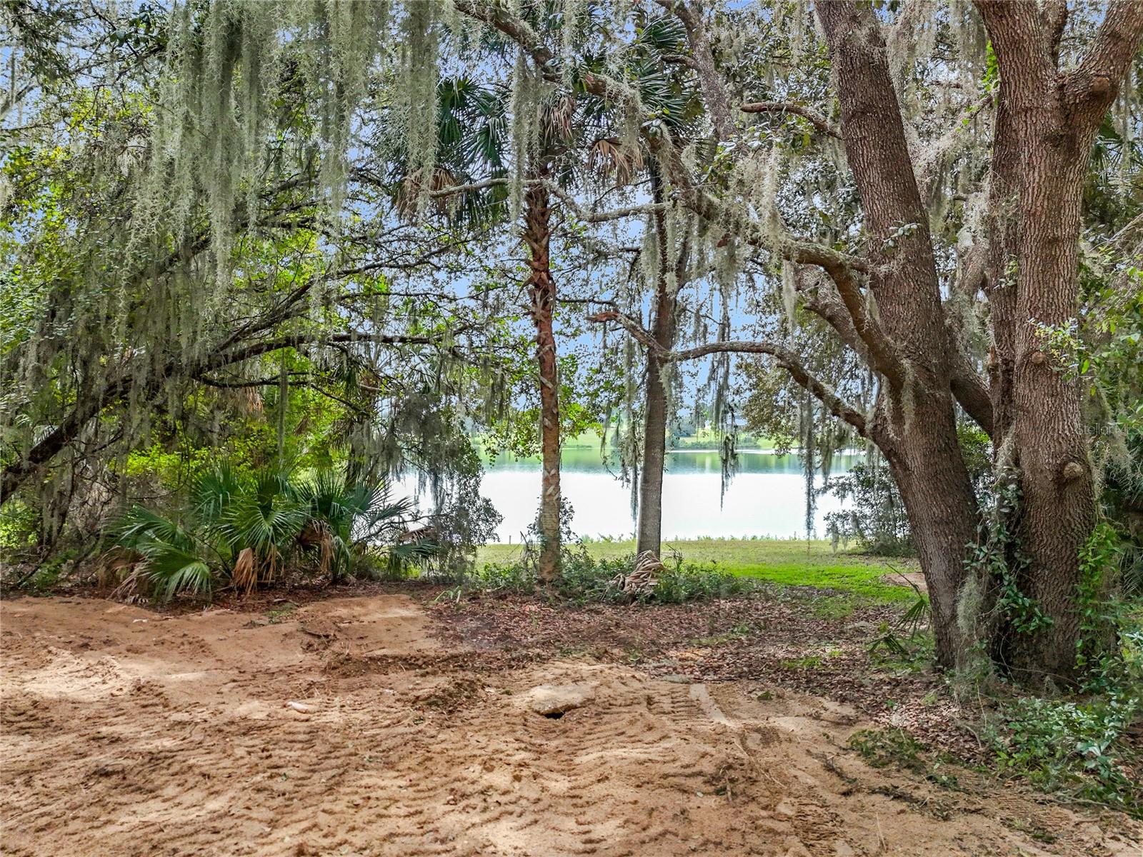 Build your dream home on Lake Black Bear!
This 0.82-acre waterfront lot in the sought-after Black Bear Reserve offers 144 feet of frontage on picturesque Lake Black Bear. Framed by mature oak trees and complete with a floating dock, it’s the perfect setting for beautiful sunsets, peaceful mornings, and weekend adventures.
Black Bear Reserve is home to the P.B. Dye–designed championship golf course and provides a lifestyle that blends luxury with nature. The community features a clubhouse, tennis courts, playground, family picnic area with floating dock and the newly added Top Tracer driving range. With low monthly HOA fees, well-maintained surroundings, and beautiful custom homes, it’s an ideal place to create your forever home.
Conveniently located just a short trip to downtown Mount Dora, Eustis, and Tavares, you’ll enjoy vibrant festivals, shopping, and dining nearby. Easy access to SR 46 and the Wekiva Parkway makes commuting to Orlando simple, and you’re only an hour to New Smyrna Beach.
Whether you’re looking to build a lakeside retreat or a custom estate, this lot is ready for your vision.