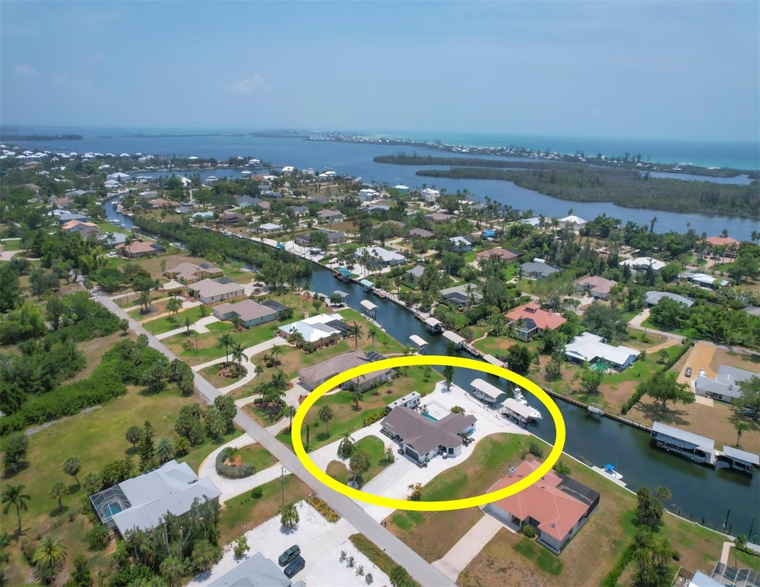 Sunsets!! Sunsets!! and more Sunsets!! While sitting in your backyard oasis enjoying the panoramic water views you will experience a different Florida sunset everyday of the year. This waterfront home offers an oversized lot (.51 acres) on a saltwater canal leading to the Intracoastal and Gulf of Mexico. If you value a great location for your activities by land or sea this home has it. Located only minutes from Boca Grande and Manasota Key beaches by car or by boat, you'll likely choose your boat.<br><br>
As you approach the front door you'll admire the Bahama shutters giving the home a coastal vibe. Upon entering the home, the first thing you'll notice is the spacious living area and large expansive wall of glass sliders leading to views of the pool and waterfront. You then enter the spacious kitchen which has been recently updated with plenty of counter space and cabinet storage. The kitchen opens to a spacious Family room that will probably be where you spend most of your time. As you exit the main living space to your expansive enclosed lanai your heart should really start to beat faster. This area features a large deck surrounding your pool and spa. <br><br>
The dock area and waterfront features are probably the most important. It allows you the ability to have your water based toys all in one spot. The area features two covered boat lifts, one being a 12,000lbs lift and the other a 16,000lbs lift, at the same time leaving room for an even bigger vessel. The home also incorporates a storage area off the back of the home for all your pool and boating items. This setup is very difficult to find and won't leave you disappointed. If you are into adventure this house needs to make your short list.<br><br>
Back inside the master suite is large and spacious with direct access to the lanai and pool area. It features a recently updated shower as well as plenty of storage space. The guest rooms are on the other side of the home and offer you and your guests much needed privacy. They share a recently updated bathroom and have access out to the pool area from their side of the home as well.<br><br>
This property has a newer roof (2023), Hurricane shutters (2020), A/C (2020), and boatlifts and canopies (2017). It also has shell landscaping over much of the property for ease of maintenance.