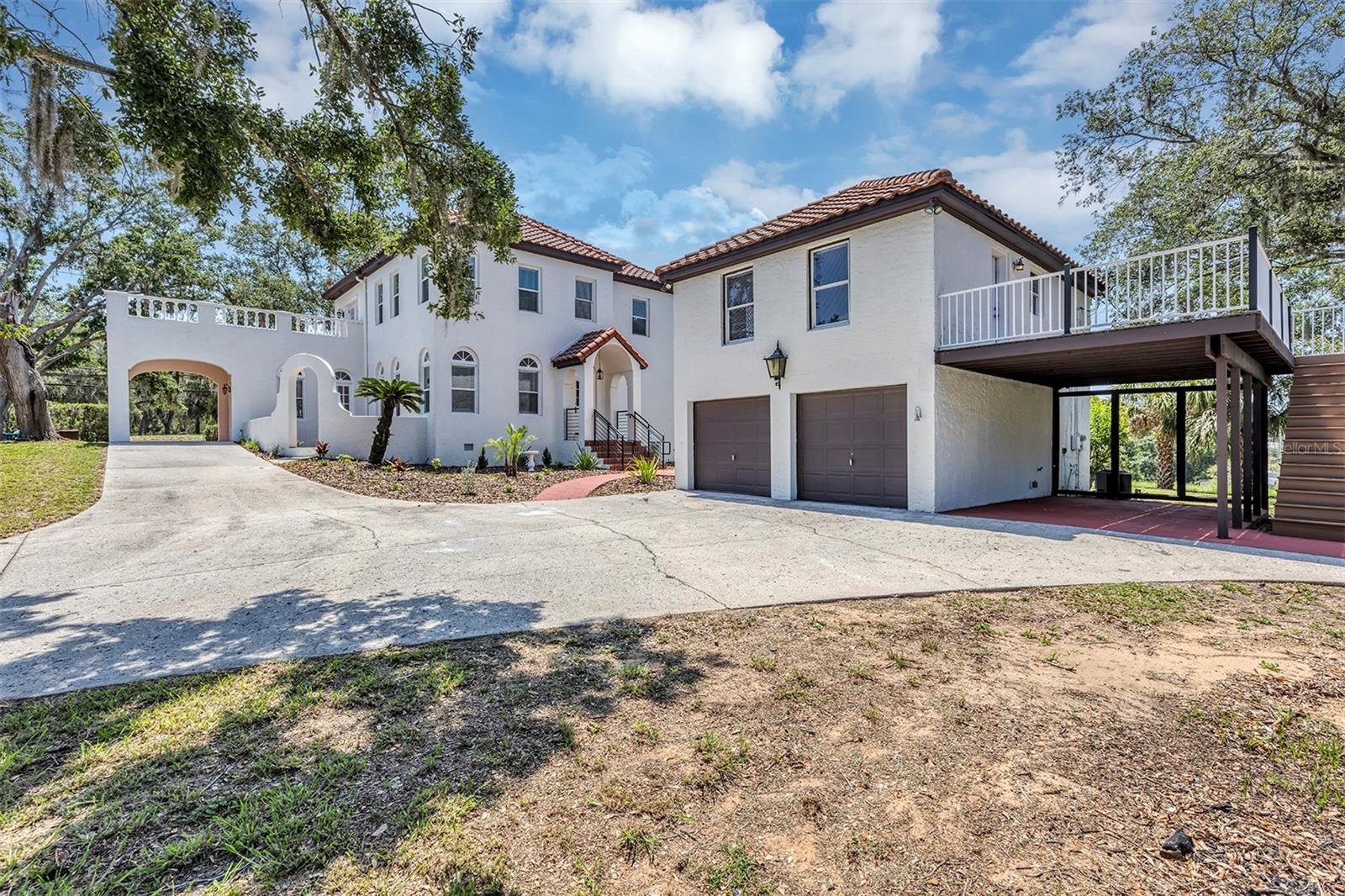 Welcome to 802 S 10th Street—a stunning 1926 Mediterranean Revival estate situated on a spacious corner lot just minutes from Downtown Haines City. Offering over 3,300 square feet of living space, this 4-bedroom, 4-bathroom property—including a detached garage apartment—seamlessly blends historic charm with thoughtful modern updates for a truly unique living experience. From the moment you arrive, you’ll be captivated by the home’s architectural details—arched windows, decorative stucco exterior, and a classic tile roof—all reflective of the golden era of Florida design. Inside, the charm continues with soaring ceilings, rich wood flooring, crown molding, and a grand fireplace that anchors the family room. The main residence features 3 bedrooms and 3 full bathrooms, a large kitchen with stainless steel appliances, generous cabinet space, and a layout perfect for entertaining. Multiple living and dining areas provide flexibility for today’s lifestyle, whether you’re hosting gatherings or working from home. A standout feature of this property is the detached guest house with its own private entrance, 1 bedroom, 1 bathroom, and kitchenette—perfect for multi-generational living, a private office, or rental income. With vintage charm, flexible living options, and income potential, this is a rare opportunity to own a piece of Florida history. Schedule your private showing today and experience the timeless appeal of 802 S 10th Street.