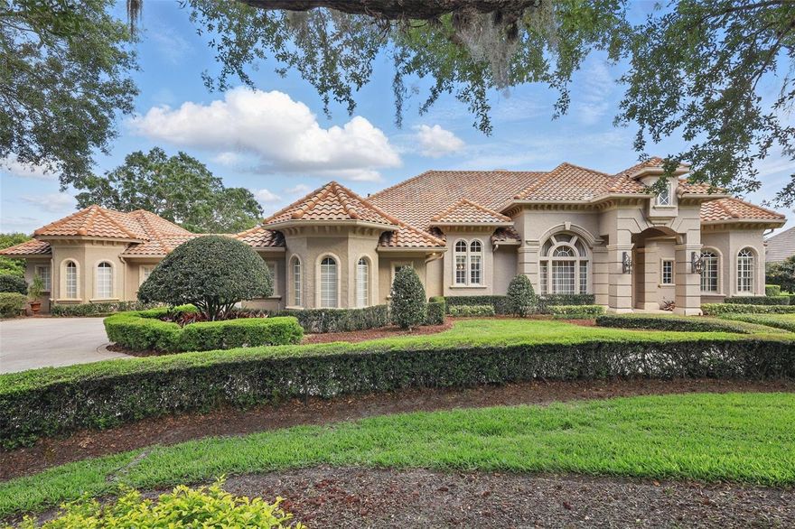 Waterford Pointe - highly sought after gated/attended community in Windermere.  This award winning Mediterranean design with nearly 200 feet of commanding water frontage on Lake Roberts boasts panoramic lake views from nearly every room. Entertaining is ideal for intimate gatherings yet amply appointed for elegant affairs, both inside and poolside! Entering through the leaded glass double doors you take in a beautiful view of the pool overlooking the lake.  There is an office/study with built-in cabinetry and desk, private primary suite with sitting area and spa-like bath with marble floors and walls, jetted tub and shower, as well as a spacious walk-in closet.  The open floor plan has travertine and hardwood flooring throughout as well as custom built-ins, shutters, custom drapes, designer features, and detailed coffered and tray ceilings.  The kitchen features updated SubZero, Monogram, and Meile appliances.  Off the great room is the game room with breathtaking views of the lake and access to the pool lanai with summer kitchen.  There is a library that adjoins the game room.  The split bedroom layout offers an ensuite and then 2 additional bedrooms with shared bath and retreat area with built-in bookcase and desk.  The laundry room/secondary kitchen features a stove, microwave, dishwasher and 100 bottle wine storage and is perfect for entertaining.  Two 2-car garages (one attached and one detached) with additional parking area is perfect for large families, multiple cars or water toys.  The detached garage could also be converted to a guest house.  Enjoy beautiful evenings relaxing or dining by the pool, sitting by the outdoor fireplace or taking an evening cruise on the lake.  Located close to Disney and other tourist attractions, shopping, dining, expressways, top-rated public schools as well as Windermere Preparatory Academy and Foundation Academy. Call today for your private viewing.