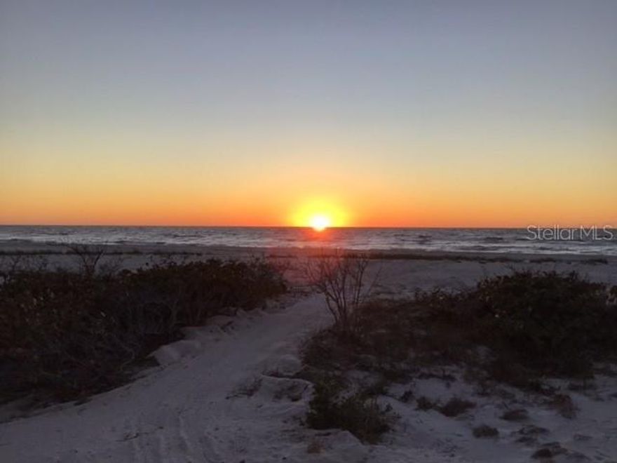 Experience breathtaking sunsets and the soothing sound of waves just steps from your door. This beautiful two-bedroom, two-and-a-half-bathroom townhome offers the perfect blend of comfort and coastal living, located directly on the Gulf of Mexico and conveniently close to downtown, restaurants, and the community center. Step out your backdoor to immerse yourself in the serene beauty of the Gulf and the surrounding nature. Features include granite countertops, screened lanais with durable Trex decking, and access to a community pool for relaxation. Don't miss this opportunity to own a slice of paradise!