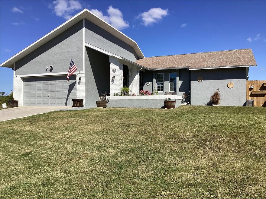 Settled in among only 14 homes on this cul-de-sac street, this home has the largest lot on the street and is the least expensive. This one was one of the few that did not flood from the hurricanes last year.
It features three bedrooms and 2 bathrooms with a two-car garage, plus an enclosed bonus room that adds to the internal heated square footage.
At the front of the home there is a spacious planter box which can hold your vibrant colorful spring flowers. The entrance has a covered walkway up to the front door.
Stepping inside there is a view of the kitchen and the living room dining room combo. With all the double pane windows there is plenty of natural light through this area.
The kitchen also features an area that will hold a smaller table for convenience. It has an open area under the upper cabinets that allows for sight into the living room.
The bonus room (TV Room) has a pass through from the kitchen and the sliding glass doors lead to the fenced back yard, via an 8 x 12 wooden deck.
The master bedroom has ample room and a walk-in closet and its own bathroom.
The colors in this home are all different colors adapted from colonial homes, and each has its own theme.
The other two bedrooms are on the opposite side of the home, divided by the second bath in the home. This bathroom was designed from an old Italian village home.
Both bedrooms on this side of the home feature their own colors and each has its own closet with plenty of storage.
The washer and dryer are housed inside its own room which also leads to the garage, and there is also space for a dedicated wash sink.
Outside, the larger lot goes back to a bird sanctuary that also buffers you from having someone building behind this home.
The garage is large enough for 2 cars, it also has attic access and houses a hot water heater and A/C system.
With the layout of the outside you might feel as if you have enough room to not feel that you are on top of the neighbors. This home is conveniently located just a mile from downtown New Port Richey. The Gulf Harbors community also offers a private beach to homeowners, where you can sit and relax to watch the sun go down, and it also features a clubhouse with a pool and spa, and there is access to the private boat ramp with canals to the Gulf. Within the clubhouse area there are also tennis courts for residents.
Don’t wait to see the home for yourself, contact the agent right away.