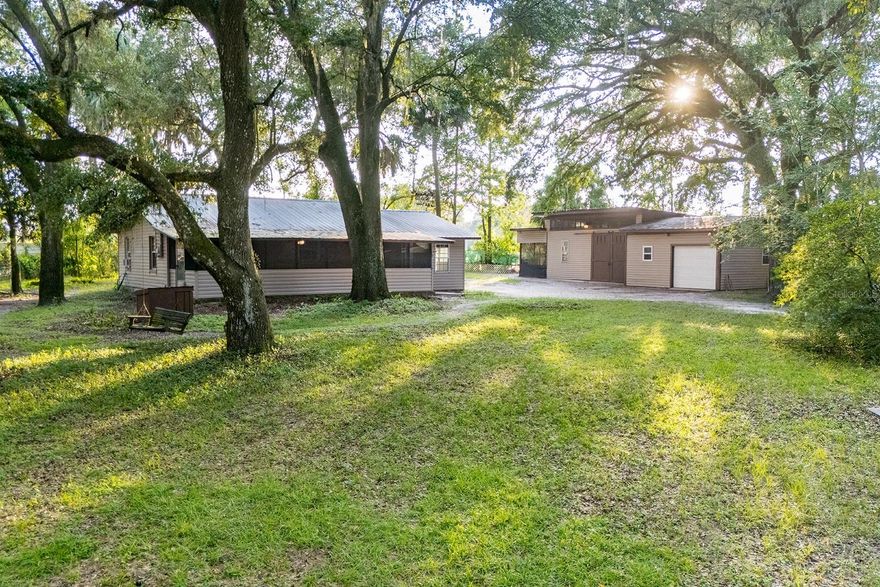Discover the perfect blend of privacy and functionality with this charming 2-bedroom, 1-bath home tucked away in Hawthorne. Set on a fully fenced 1.22-acre lot, this property offers plenty of space for both relaxation and projects. Just a stones throw to Grove Park! Step inside to a cozy living space featuring a wood-burning fireplace, ideal for gathering on cool Florida evenings. The large screened front porch is perfect for sipping your morning coffee while enjoying the peaceful surroundings. Outside, you’ll find a detached oversized workshop, providing plenty of room for hobbies, storage, or even a small business setup. Whether you’re looking for a homestead, a quiet getaway, or space to expand, this property offers endless opportunities—all just a short drive from Gainesville, Palatka, and area lakes. All of this listed at under $250,000!!