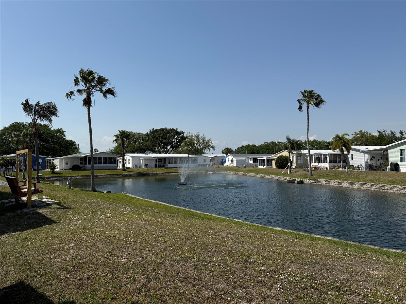 New Price, Same Opportunity! Welcome to 215 S Port Royal in Apollo Beach, where opportunity knocks with this affordable THREE-bedroom, TWO-bath manufactured home. The guest bathroom has already been updated. If you’ve ever dreamed of putting your own personal touch on a home, this is your chance to make it happen. PRICED TO SELL, this property offers the perfect canvas to create your Florida dream retreat. Step outside to your backyard oasis and take in the peaceful view of the POND, complete with a beautiful fountain that adds a touch of tranquility to your day. Whether you’re sipping your morning coffee or unwinding in the evening, the calming sound of the water will make you feel right at home. Located in Caribbean Isles Residential Cooperative, an active 55+ manufactured home community, you’ll never run out of things to do. The community is known for its vibrant social scene and a wide range of amenities designed to keep you active and engaged. Whether you enjoy group activities, crafts, games, or just relaxing by the pool, there’s always something going on. The location couldn’t be more convenient. Just down the street, you’ll find popular spots like First Watch for breakfast, Starbucks for your coffee fix, and Publix for groceries. A new Walmart and Aldi are coming soon, giving you even more options. For your healthcare needs, TGH Urgent Care and CVS are just minutes away. This home is perfect for someone ready to take on a project and make it their own. With some TLC, you can transform it into a cozy and comfortable space tailored to your tastes. Embrace the opportunity to invest in your future while enjoying all the comforts of a welcoming community and the convenience of nearby amenities. Don’t miss your chance to own a piece of Apollo Beach at an incredible value. Bring your ideas and your vision — this is your opportunity to create the home you’ve always wanted. Schedule your showing today and see the potential for yourself!