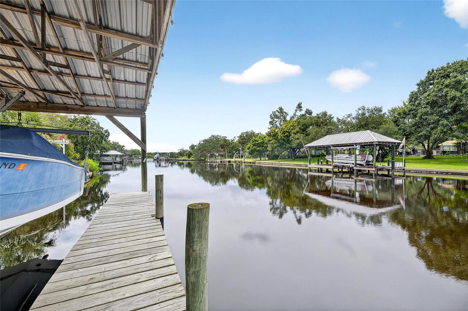 WATERFRONT LIVING in RIVERVIEW! This beautifully remodeled 3-bedroom, 2-bath single-family home offers 1,835 sq ft of heated living space on a generous 1/3-acre lot with direct water access to the Alafia River and beyond. Nestled on a quiet dead-end street, this property is perfect for boaters (includes boat dock with lift) and outdoor enthusiasts, featuring a boathouse, boat lift, and in-ground concrete pool.
The split-bedroom floor plan offers privacy and functionality, while the freshly updated interior boasts new appliances (refrigerator, dishwasher, garbage disposal), flooring, paint (interior & exterior), plumbing, roof (transferrable Warranty), and more. Improvements completed August 2025 include ceramic tile flooring throughout, kitchen cabinets. quartz kitchen countertops, closet and interior doors throughout, bathroom vanities & ceramic wall tile, new water heater, septic lift station control box and a new boat lift motor (one of two). Previous (recent) improvements include new pool pump (2024), septic lift station pump replaced (1/2024), new HVAC (8/2023), pool resurfaced (2018), replumbed with overhead piping (2011). Enjoy relaxing in the spacious screened porch or take advantage of the covered carport and extra storage building for all your gear.
Interior laundry, mature landscaping, and modern finishes throughout make this home truly move-in ready. Ideally located between SR-41 and Hwy 301, you’re just minutes from shopping, dining, and commuter routes — but worlds away in your own private waterfront oasis with daily stunning sunsets.