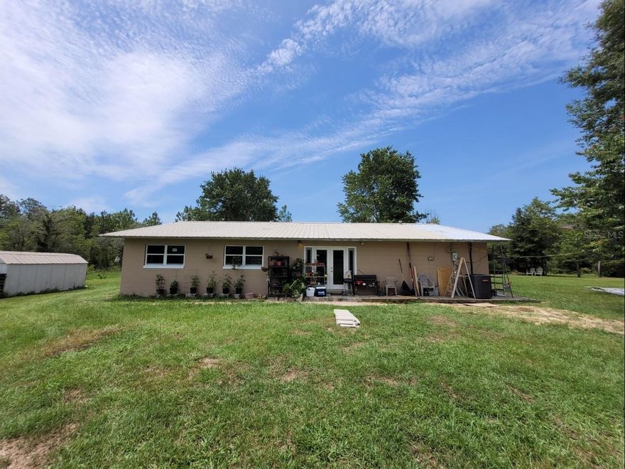 4/2 block home on 10 acres. Very private property at the end of dead end unpaved roads (front gate and back gate).

Within the last 5 years, new metal roof, new electrical, new plumbing, new septic, new windows, new water heater, new HVAC system, new washer and dryer. Home completely updated with new bathroom fixtures, kitchen cabinets, counters and appliances, ceiling fans, outlets, doors, paint and flooring.

Septic tank was just pumped and drain field certified 02/2025.

The 10 acres are fenced in and have two different ways of accessing the property. The back gate is at the end of a county maintained cauldisac in 5 Oaks and the front gate is at the dead end of a private sugar sand road. This property is the only one that connects the two sides.

There is an 8x12 potting shed, a 10x14 metal shed and a huge chicken coop that sustained minor fire damage but can be repaired. 

There are wild grapes, blackberries and blueberries all over the property. Also several young fruit trees including 2 pear trees, a peach tree, 2 fig trees, a few banana trees and a ruby red grapefruit tree. 
The home is on a well that goes straight into the Florida aquifer. Best ph balanced water ever!
This property is really lovely. It is just 36 miles from the WEC in Ocala and 12 miles from Gainesville.