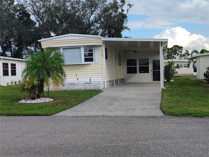 Welcome to 6502 Hikina Drive in North Port, Florida — nestled in the desirable Holiday Park 55- plus community, where you own the land.
This charming, fully furnished two-bedroom, one-and-a-half-bath home offers bright living spaces filled with natural light.
The cozy living room is perfect for relaxing, and the crisp kitchen features a stylish backsplash and plenty of cabinet space.
Both bedrooms have the feeling of comfort and flexibility — ideal for guests or a home office — with beautiful flooring throughout.
You’ll appreciate the convenient laundry and bonus area, plus a newer roof, air conditioning, and water heater.
Holiday Park residents enjoy a gated community with two pools, clubhouse, tennis, and social activities — all for low annual fees.
This home is move-in ready and well maintained. This very popular park  offers 2 pools, pickleball, shuffleboard, Bocce courts and a fitness center in the Heart of North Port. Walking distance to shopping. Very active park with lots of amenities to keep you busy and engaged in the community. The seller has it treated for insects by Terminix quarterly. 
Water Heater 3 yrs old and re-piped, Roof was replaced in 2014, AC is regularly serviced and is 2016.Mold and leak detection has been done and is clear.
With just a 15-20 min drive to local beaches and Malls. Wellen Park offers great shopping a dinning as you watch an ATLANTA BRAVES GAMES.
HOLIDAY PARK offers Storage for boats, campers and trailers available.(extra fee) So many activities to keep you busy with plenty of card games and parties! Park Application and approval is required with a $50 application fee. One owner must be 55 yrs or older and the other 45yrs or older.