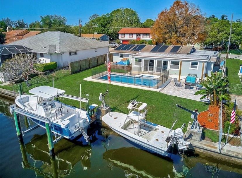 Welcome to Paradise – Waterfront Living at Its Finest! Enjoy life on the canal with direct access to the Manatee River from your own backyard, featuring two boat lifts for all your water adventures. This beautifully updated 3 bedroom, 2 bathroom 1,920 sq ft home offers wood plank tile throughout, a remodeled kitchen, and a heated pool perfect for year-round enjoyment. The large fenced yard provides privacy and space, while lawn and pool maintenance are included for a truly carefree lifestyle. Conveniently located just minutes from shopping, dining, outlet stores, I-75, and stunning Gulf beaches.