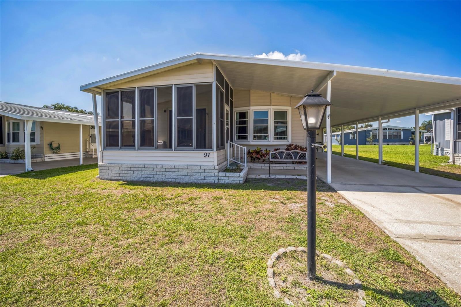Looking for a highly sought after 55+ community in Winter Haven with NO LOT RENT? Well look no further! Become a shareholder in one of the most popular 55+ communities in Winter Haven, Orange Manor West. With a Pool, mini golf course, horse shoes, shuffle board, bingo, crochet, LAKE ACCESS, and so much more, you'll always have some form of entertainment to keep you living an active lifestyle. This wonderful 2 bedroom 2 bathroom home, that can come FULLY FURNISHED, will surely not disappoint with its well-kept interior AND exterior. The metal roof on this home was replaced just 7 years ago and there is an updated storage shed providing plenty of room for storage needs as well as a laundry room away from the outside elements. As you enter the home, you'll be greeted with new flooring throughout the living spaces and newer updated double pane windows. The updated ENCLOSED Florida room adds another space for entertaining or make it a nice office or craft room, whatever suits your needs. Both bedrooms are of ample size with the primary offering an en-suite bath with dual sinks and shower tub combo. The bright and airy kitchen provides plenty of counter space which extends into the eating area for easy entertaining. This home is easy to show, so don't miss the opportunity to see all that it and the community of Orange Manor West has to offer and make it yours!