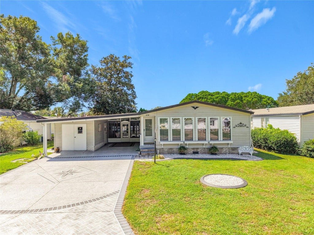 Photo of 658 Rainbow Boulevard, Lady Lake, FL 32159 (MLS # G5117705)