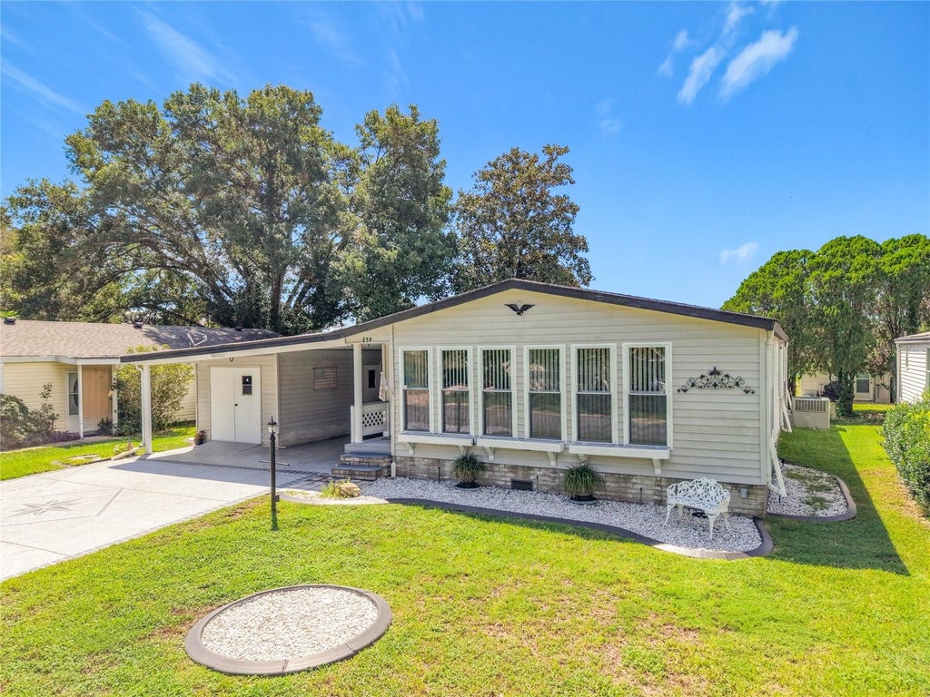 Photo of 658 Rainbow Boulevard, Lady Lake, FL 32159 (MLS # G5117705)