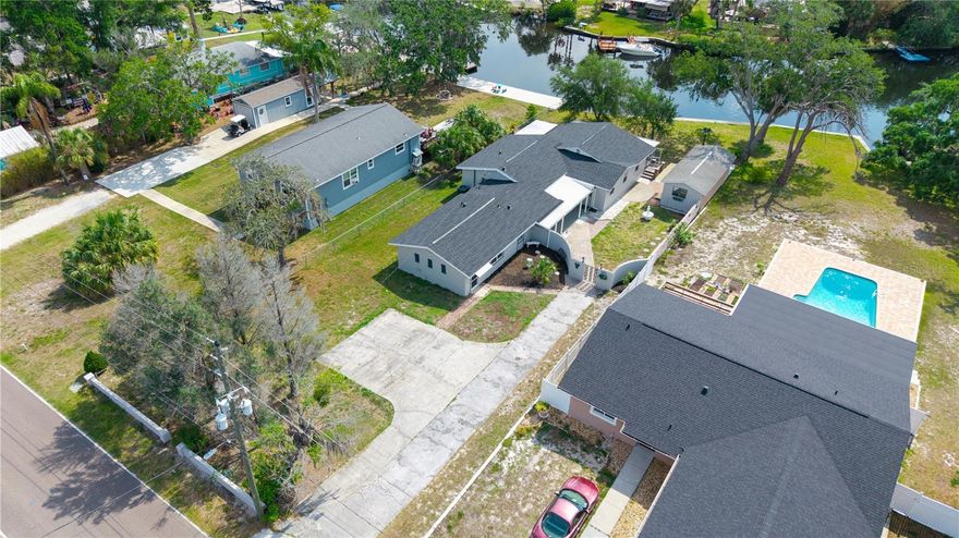 WATERFRONT! FULL IN-LAW QUARTERS/GUEST SUITE/APARTMENT with its own private entry and separate electric. RARE FIND!!! Great for Airbnb income producing! Home is TOTALLY REMODLED! BRAND NEW ROOF! House has 2,283 of living sq.ft with a total of 3,123 sq.ft. total under roof. Main house features 3-bedroom, 2-full bathroom, huge Bonus room/theatre room/game room, and living room both overlooking an unbelievably beautiful, tranquil, and breathtaking 83 feet of deep-water frontage, dining room, granite countertops, inside laundry room, ALL NEW Granite countertops, cabinets, stainless steel appliances, plantation shutters and blinds throughout, hurricane sliding doors, large 30X15 side porch, large 31X8 fully screened-in rear porch overlooking river,11X20 fully enclosed glass side lanai(possible 4th bedroom), outside open patio area for BBQ, huge side open garden area with a private security wall and wrought iron gate, fully reconstructed newer concreate seawall and so much more!  IN-LAW QUARTERS/GUEST SUITE/APARTMENT features: 1-bedroom, 1-full bathroom w/large glass shower stall, Brand New kitchen cabinets, granite countertops, brand-new stainless-steel appliances, private entry and parking, open kitchen, eat-in kitchen area, living room and so much more! NO HOA! NO CDD FEES! NO DEED RESTRICTIONS! Additionally, the property has an extra-large driveway with plenty of room for RV or boat along with an additional side driveway for apartment, HUGE separate side yard 12X32 building workshop with sliding glass doors, work-bench, possible gym, or additional future guest house. Come enjoy fishing, kayaking, jet skiing, nights of grilling, boating right from your very own backyard and enjoying life looking out the extremely large pitcher window of that breathtaking panoramic view of the river under Oak Trees. Close to shops, restaurants, easy commute to and from Sun Coast/Veteran’s Highway, close to world-famous beaches, golf courses, Busch Gardens, culture and sport events in the Tampa and St. Petersburg area. Tampa airport and Tarpon Springs, Sponge Docks. COME SEE FLORIDA’S LIFESTYLE AT ITS BEST!!! A TRULY WATERFRONT PARADISE!