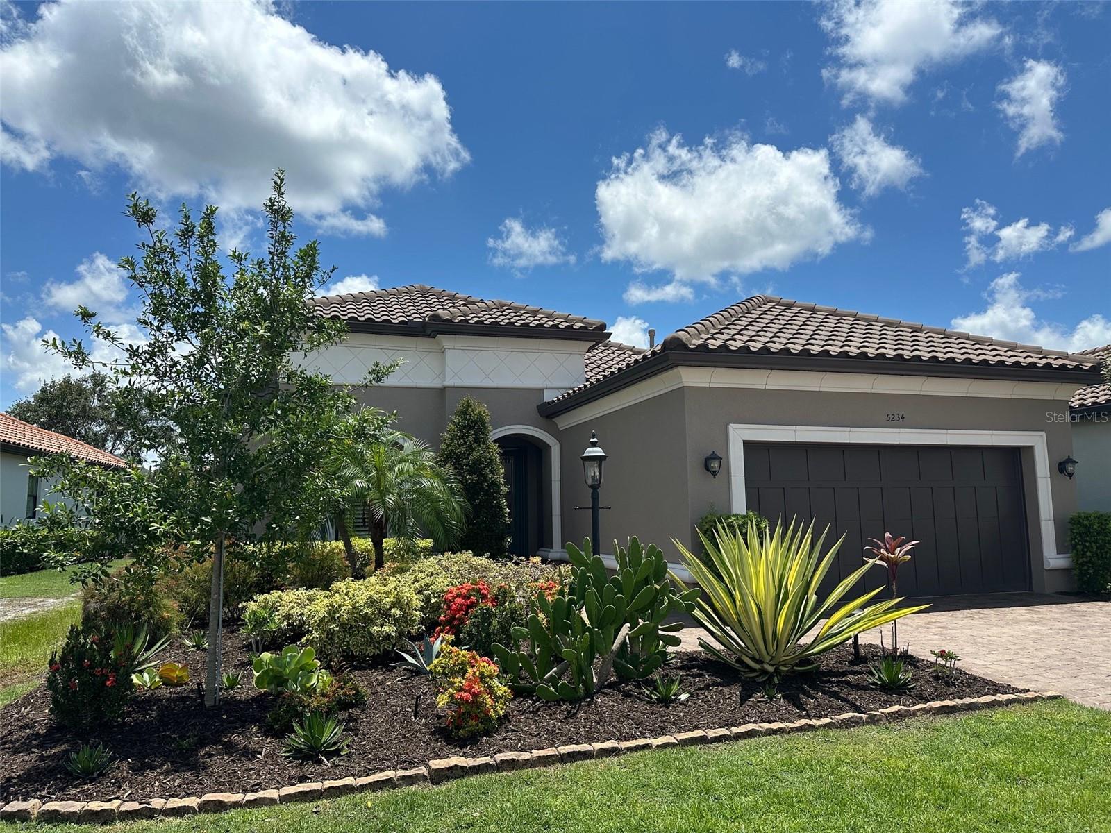 GOLF INCLUDED! The den is currently a 3rd bedroom and an there is an additional flex room currently used as a den but can also be a formal dining room. Welcome to resort-style living in the highly sought-after Esplanade Golf & Country Club in Lakewood Ranch—where a deeded golf membership is included and every day feels like a vacation! Curb appeal abounds with lush tropical landscaping, a paver driveway, and a durable tile roof that sets the tone for this beautifully maintained home. Enjoy peace of mind with impact-resistant windows, built to withstand Florida’s toughest weather. You'll appreciate the attention to detail throughout, including porcelain plank tile flooring, plantation shutters, designer window treatments, and crown molding. The chef’s kitchen features a gas range, quartz countertops, closet pantry, and a large center island—perfect for entertaining or casual meals. The owner’s suite is a luxurious retreat with a custom walk-in closet and an ensuite bathroom offering dual vanities and a walk-in shower. A second bedroom also includes a custom closet and ensuite bath, ideal for guests. Step outside to your extended paver lanai, where you can dine alfresco, sip morning coffee, or relax in the private hot tub. With HOA-provided lawn care, you can leave the lawnmower behind. Enjoy every amenity available at Esplanade: Championship golf, Tennis, Pickleball & Bocce Ball, Fitness center & Resistance Pool, Resort-style pool with Lap Lanes and Beach Entry, Wellness Center, The Bahama Bar, a Poolside full-service bar and restaurant, Culinary Center and Barrel House. Located in Lakewood Ranch, near A-rated schools, top medical facilities, and a wide variety of shopping and dining. This home is just a short drive to Sarasota, the Gulf beaches, and within 45 minutes of the Tampa/St. Pete metro area. Enjoy an easy lifestyle with more time for fun—whether you're golfing, lounging by the resort pool, or enjoying dinner with friends at the Bahama Bar. This is more than a home—it's your gateway to the Florida lifestyle you deserve. Schedule your private tour today!