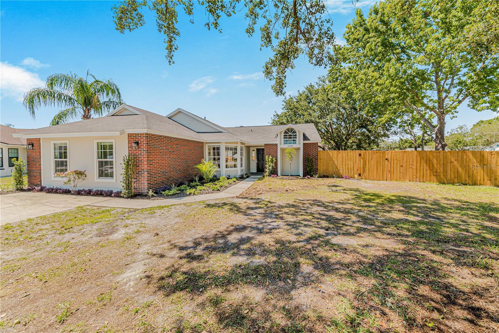 Incredible 4 Bedroom, 2 Bathroom home in sought after South Lakeland area with NO Hoa!!! This beautiful home has just undergone an extensive remodel and features new tile floors throughout, custom grey kitchen cabinets with Quartz countertops, stainless appliances, high ceilings, remodeled bathrooms with custom vanities, Benjamin Moore designer selected paint colors inside and out, tons of natural light, a fireplace, and an extremely open floorplan with tons of natural light!!! The home also includes new insulation, a New AC compressor, a New Hot water heater, and the roof is only 8 years old! There is a full privacy fence for the huge yard, a large covered and screened lanai with room for a dining table and chairs, a firepit area with slab, and much more. The bedrooms are all large with dedicated closets and the master even has two walk-in closets! There is a large indoor laundry room and lots of room for extra storage in this house including the extra wide hallway to the guest bedrooms which is perfect for organizing personal items such as toy play area or hobby items! The home is on a corner culdesac lot so the side yard is also huge and the driveway is extra long with plenty of room for parking! Plenty of room for paring trailers as well! This is a completely move in ready home with tons of upgrades and the designer style finishes everyone is looking for. Schedule your showing today while it is still available!