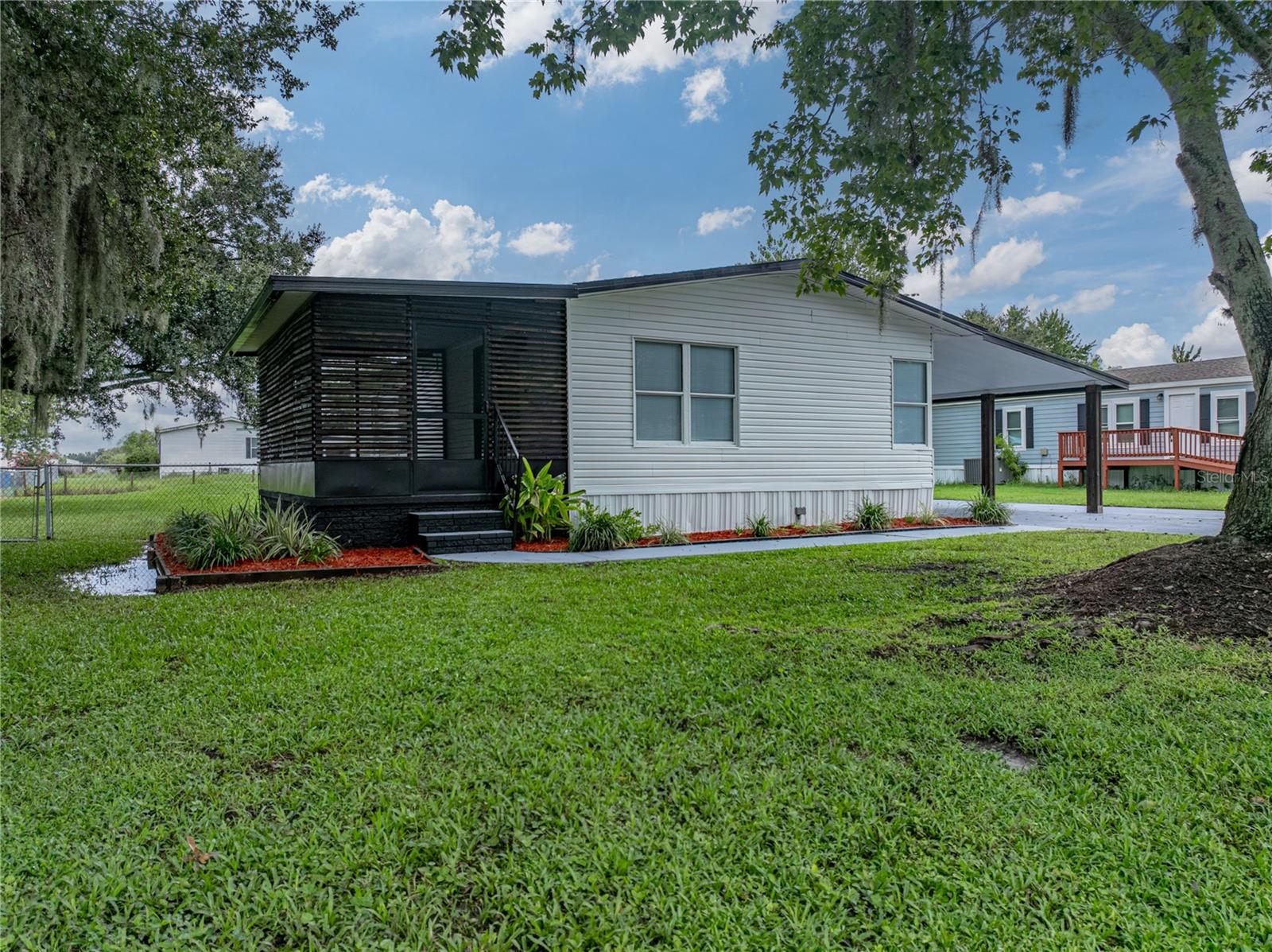 Welcome to this beautifully renovated two-bedroom, two-bathroom manufactured home that combines modern updates with everyday comfort. Featuring an open floorplan and thoughtful upgrades throughout, this home offers both style and functionality in a convenient location—without the restrictions of an HOA. Inside, you’ll find vinyl plank flooring that flows seamlessly through the living areas, creating a clean and contemporary feel. Freshly painted bright walls provide a blank canvas for you to make every inch of this home your own. The updated cabinetry and remodeled bathrooms add a fresh, modern touch, while the enclosed patio provides flexible space perfect outdoor gatherings or barbecues. The spacious primary suite includes a private bathroom, while the secondary bedroom and bath are ideal for family or visitors. The open layout makes the kitchen, dining, and living areas flow together beautifully, creating an inviting space for gatherings and everyday living. Outside, the property continues to impress with a fully fenced-in backyard, perfect for pets, play, or outdoor entertaining. Under the carport, you have a small workshop/storage area and in the backyard a storage shed adds convenience, giving you extra room for tools, equipment, or seasonal items. With no HOA, you’ll enjoy the freedom to truly make this home your own. Move-in ready and full of modern updates, this property is a wonderful option for those seeking comfort, flexibility, and value.