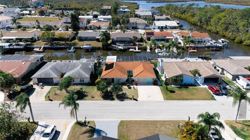 Price Reduced For Quick Sale!!                                                                                                                                                       Ultimate Florida Waterfront Living. Experience the best of Florida coastal luxury in this fully remodeled 3-bedroom, 2-bath. Gulf-access pool home, where modern elegance meets relaxed waterfront charm. Listing agent is the owner. Turn-Key, move in ready property with excellent potential as an Airbnb or short-term rental investment. Functional layout, low maintenance, and desirable location make this home attractive for both personal use and income production. Located in the sought-after Westport community at the end of a peaceful cul-de-sac, this residence offers direct tidal canal access to the Gulf of Mexico—perfect for boating, fishing, kayaking, or enjoying breathtaking sunsets.
Inside, an open-concept design highlights porcelain tile and luxury vinyl plank flooring, modern lighting, and a chef’s kitchen featuring soft-close cabinetry, quartz countertops, premium stainless-steel appliances, and a stylish island overlooking the pool and canal. The electric fireplace and wet bar add warmth and sophistication to the living space.
The primary suite opens directly to the pool area and includes a spa-inspired bathroom with a frameless glass shower and dual vanity. Both bathrooms showcase high-end contemporary finishes, and the laundry area is discreetly tucked behind a charming barn door.
Step outside to a true Florida oasis — a screened lanai with a heated, resurfaced large 14' x 32' pool, and an 8’x12’ floating dock with thruflow decking and aluminum benches. Enjoy the freedom of no HOA, no CDD, and endless opportunities for waterfront recreation. The house is Permitted and the Flood Insurance Policy is valid and transferrable until November 2027.  Centrally located just 45 minutes from Tampa International Airport and minutes from downtown, shopping, dining, and beautiful state parks, this home offers the perfect blend of comfort, convenience, and coastal living.
This is more than a home — it’s your private slice of paradise.
Live the ultimate Florida waterfront lifestyle today.