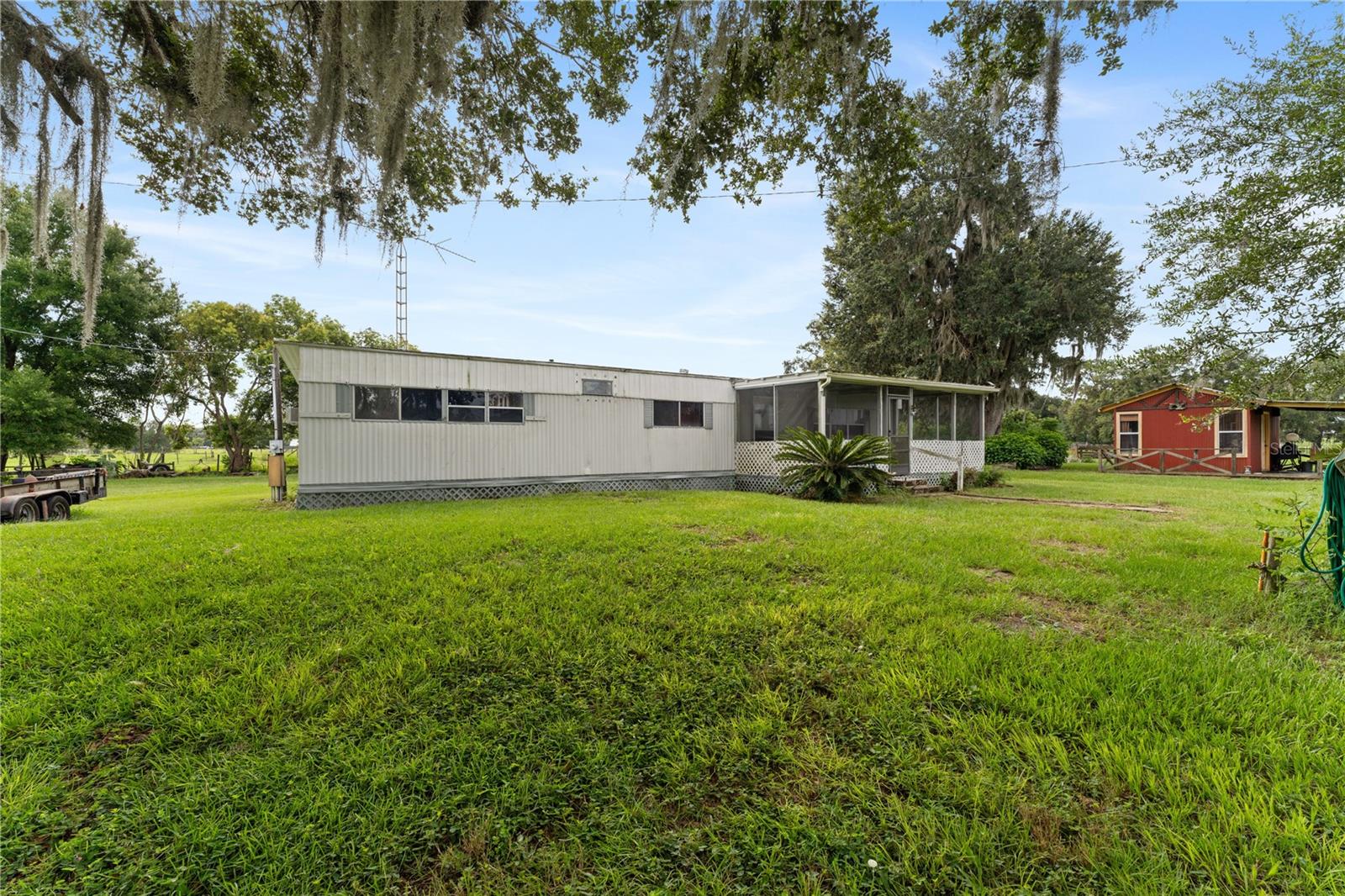 Beautiful 20.2 Acres with 3 Bedroom Home, 24x52 Metal Building, 12x14 She Shed, Double sided barn. All buildings have Power and Water! Entire property is Fenced and Cross Fenced. This a working farm with cattle, horses and more... Located adjacent to many newer homes on acreage and working farms. This property is located near the future development area for The Villages. Property can be split. You can have a family compound, a weekend retreat, commute to Tampa or Orlando. Come see this amazing property today!
