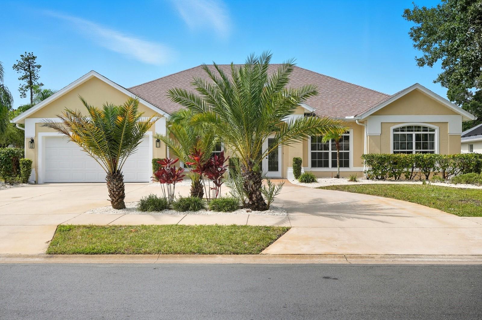 Best Value in Palm Coast — Nearly 2,400 Sq Ft, Gorgeous Landscaping,HUGE FENCED IN YARD, and a Dream Pool Oasis!
Welcome to one of the best values in Palm Coast—this spectacular concrete block Pool Home in the highly desirable Lakeview community offers just under 2,400 square feet of beautifully designed living space with four bedrooms and three full bathrooms. Tucked away in a charming circle of homes that surround a tranquil lake, this neighborhood offers underground utilities, sidewalks, and streetlights, all with very low HOA fees, giving you both convenience and character that’s hard to find.
From the moment you arrive, the curb appeal makes an impression. Professionally landscaped grounds with concrete curbing and gorgeous mature palm trees create a lush tropical setting. The freshly painted exterior and elegant circular driveway add to the appeal, providing both beauty and plenty of parking for family and guests.
Inside, soaring ceilings and an open, airy layout make the home feel inviting and spacious. Tile and wood floors flow throughout with no carpet anywhere. The flexible design features not just one but two potential en suites, making this an ideal setup for families living together, guests, or anyone needing extra privacy. In addition, there is a dedicated full pool bath—perfect for entertaining and everyday convenience. The floor plan also includes a home office or sitting area, a formal dining room, and a large family room that seamlessly connects to the upgraded kitchen. The kitchen shines with granite countertops, custom wood cabinetry, and plenty of room for gathering, while storage is abundant with multiple closets, a spacious garage, and an inside laundry room.
The outdoor living is where this home truly shines. A massive screened pool deck offers the perfect space for entertaining year-round. Whether hosting barbecues, lounging in the sun, or enjoying quiet evenings, the 2025 resurfaced in-ground pool is ready for endless enjoyment. The oversized fenced backyard adds even more room to play, garden, or relax, making it a dream space for both kids and pets.
All of this comes in a prime location close to schools, shopping, dining, and only 15 minutes from the beach. With upgrades already complete—including fresh exterior paint, a resurfaced pool, beautiful landscaping, and upgraded finishes—this home is move-in ready and a rare find in today’s market.