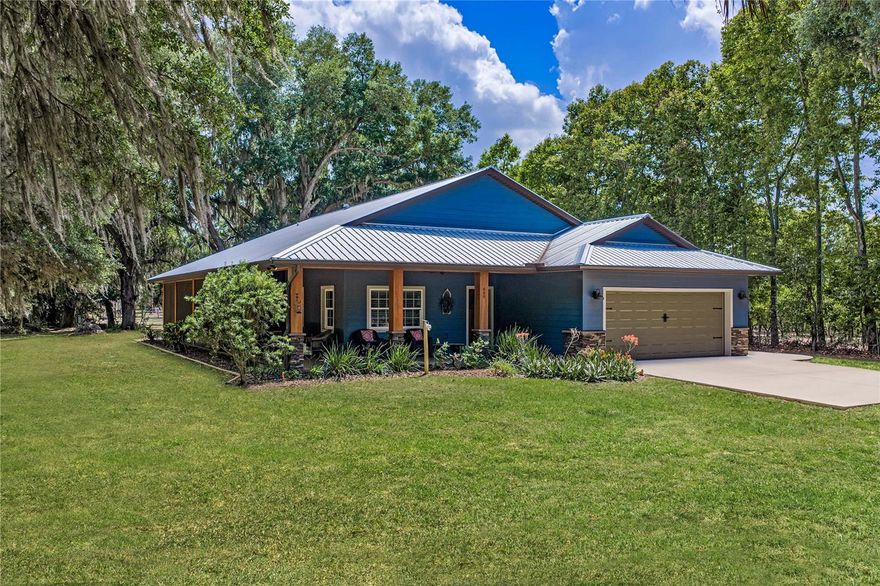 A private escape, thoughtfully designed for both refined living and equestrian life! This custom-built home, completed in 2019, offers over 2,000 square feet of living space and is set on 8.99 acres that are entirely fenced and cross-fenced, high and dry, and ideal for horses, livestock, or those seeking usable acreage and privacy. Expansive front, rear, and side porches offer beautiful views of the serene property and create the perfect setting for enjoying the outdoor lifestyle.
Designed with versatility in mind, this property is exceptionally well-suited for equestrian and agricultural use. The front pole barn is constructed with red-iron I-beams and features a new roof, offering ample space for livestock, equipment, boats, RVs, and recreational toys. A separate equestrian barn includes steel trusses, metal siding, water and electricity, a tack room, and four stalls. The land is divided into four pastures, a functional and efficient setup.
Additional property features include irrigation, a 4-inch well, a whole-house generator, a durable metal roof, mature oak trees, and fruit trees, creating both beauty and long-term value.
Inside, the home features luxury vinyl plank flooring, an electric fireplace, beautiful wood beams, solid-wood cabinetry, granite countertops, a large island, a farmhouse sink, and a pantry. The spacious primary suite features French doors that open to a screened porch, a walk-in closet, a private water closet, a double-sink vanity, and a large walk-in shower. Secondary bedrooms and guest bath are generously sized and thoughtfully designed. Additional highlights include a dedicated office or flex space with built-in cabinetry and a countertop, a well-appointed laundry room, a two-car garage, and multiple covered porches featuring tongue-and-groove wood ceilings with ceiling fans. A hot tub located on the rear porch that creates the perfect place to relax after a day spent outdoors.
This is a rare opportunity to own a move-in-ready equestrian and livestock property offering high-and-dry usable land, quality improvements, and a peaceful rural lifestyle without sacrificing comfort or style.