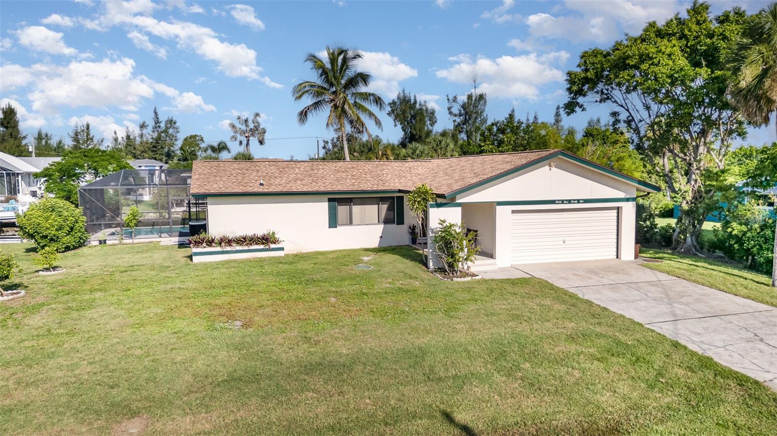 Welcome to 3425 Magnolia Way – your waterfront retreat in Punta Gorda. Discover the perfect blend of comfort, convenience, and coastal charm in this beautifully FURNISHED 3-bedroom, 2-bath waterfront home. Nestled in one of Punta Gorda’s most desirable locations, this thoughtfully designed residence features over 1,500 square feet of living space and a split floor plan ideal for privacy and everyday living. Step outside to your own slice of paradise, complete with a sparkling pool, resurfaced lanai, and a spacious screened-in outdoor area – perfect for entertaining or unwinding in the Florida sunshine. Boaters will love the private dock, boat lift, and quick, direct access to Charlotte Harbor and open waters. Recent updates add comfort and peace of mind, including a new roof in 2023, new AC in 2024, laminate flooring, a beautifully renovated primary bathroom shower, a tiled front walkway and porch, and a paved path leading to the dock. Ideally located just minutes from downtown Punta Gorda’s boutique shops, waterfront dining, and the popular Saturday Farmer’s Market. Travel is a breeze with Punta Gorda Airport (PGD) and convenient Allegiant flights just a short drive away. Pickleball enthusiasts will enjoy close proximity to the renowned PicklePlex, and Gulf Coast beaches like Fort Myers and Englewood are less than an hour away. Whether you're seeking a year-round residence, seasonal escape, or investment opportunity, this waterfront gem offers the ultimate Southwest Florida lifestyle. Don’t miss your chance—call today to schedule your private showing!