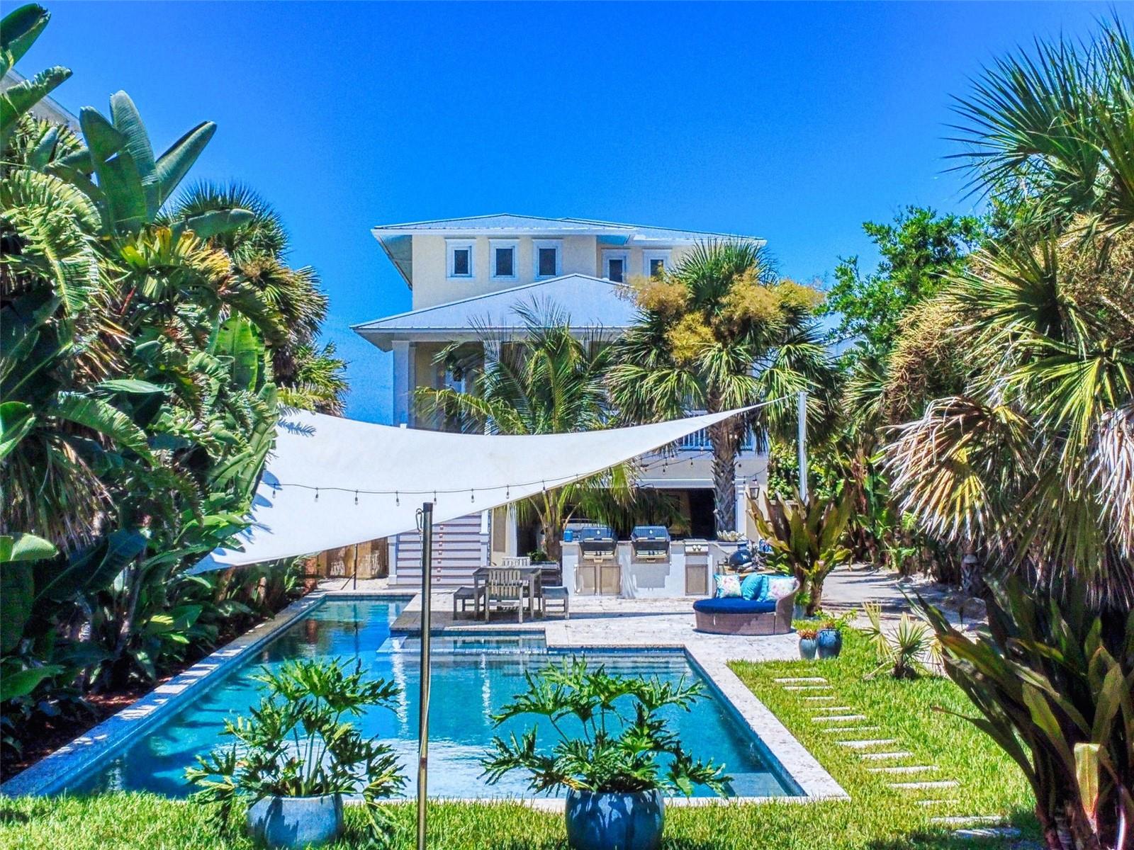 An exceptional rental opportunity awaits with this breathtaking 4-bedroom, 3.5 bath beachfront retreat—complete with a private dune walk to the ocean. Luxury defines every inch of this stunning multi-level pool home, offering panoramic views of the sparkling Atlantic Ocean. Newly built in 2017 and impeccably designed from top to bottom, this resort-style residence blends elegance with comfort. Outside, enjoy a full outdoor kitchen overlooking a custom coquina stone pool deck—perfect for dining, lounging, or simply floating your cares away. Just steps away, the second-floor wraparound balcony invites you to soak in the ocean breeze. Inside, every floor features its own balcony, starting with the first level that includes two spacious bedrooms and a full bath. The second floor opens to a vast living area, a chef’s dream kitchen, and a separate dining room—all with ocean views and direct access to the balcony. A 3rd bedroom with full bath and full utility room with porch access adds convenience to this level. The top floor is dedicated to the Owner’s Suite, where birds-eye views of the ocean meet the warmth of a cozy gas fireplace. This elegant space includes a private balcony and an adjoining area ideal for a home office, personal gym, or studio. The expansive bath features double sinks, a garden tub, walk-in shower, and separate water closet, while the custom California-style walk-in closet completes the suite. With every modern convenience, an oversized two-car garage, and endless spaces for entertaining or unwinding, this home is just a salty breeze away from the sugar sands of New Smyrna Beach. Put the phone down, kick off your shoes, and let the ocean set the pace.
