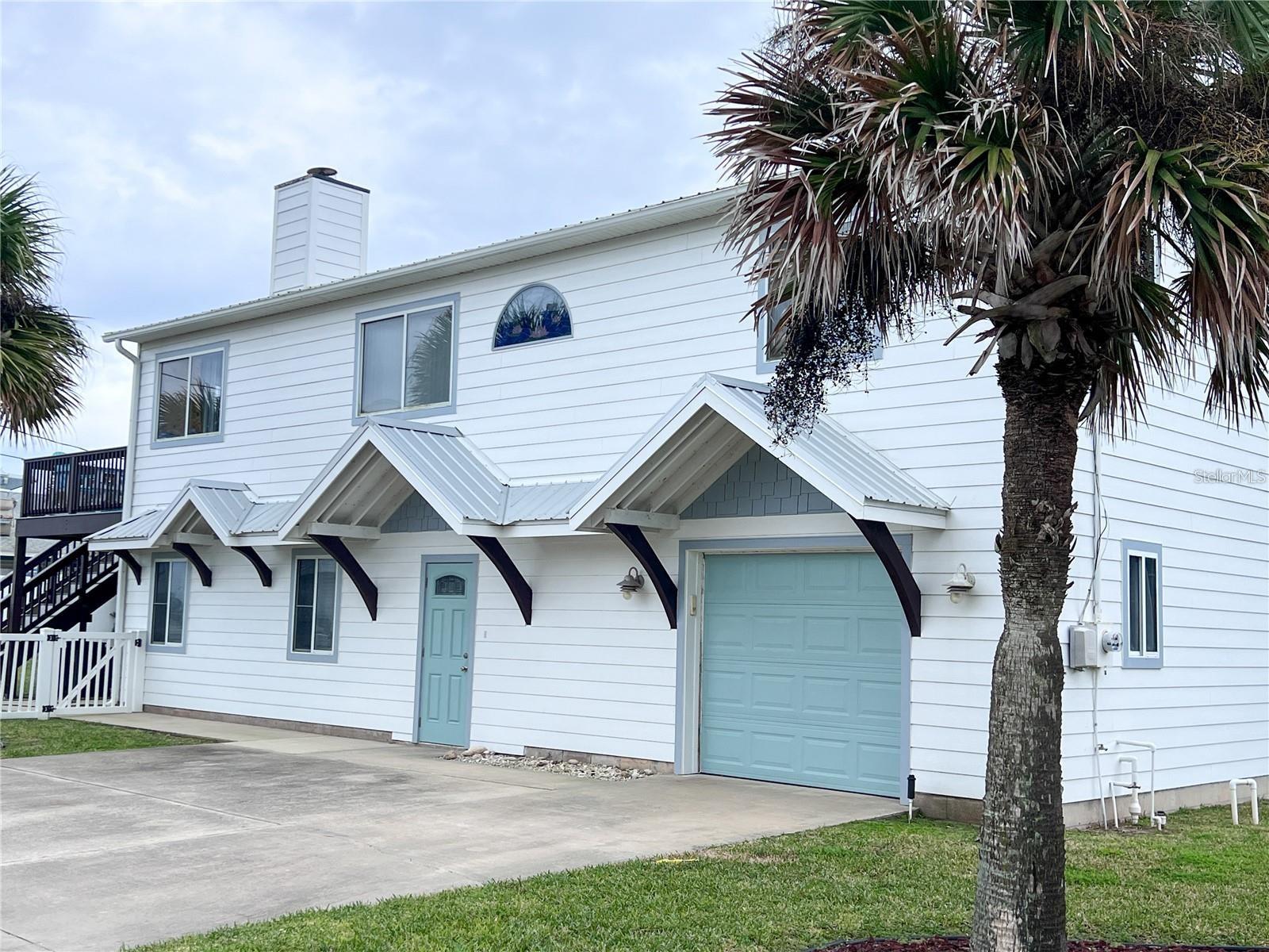 Located on the "Ocean Block", this rental is steps away from the cinnamon sands of Flagler Beach and the Atlantic Ocean. Utilities - electricity, WIFI, water, sewer, trash, pest control and lawn care is a $350 per month flat additional fee. This charming beachside duplex first floor rental has a private entrance, fully fenced back yard, firepit and rear covered porch with a picnic table accessed by sliding glass doors. This unit is furnished, but there's plenty of room to add your extra personal touches. Laundry is available in the garage shared by owner, who owns the top floor used as a vacation getaway for herself and family. There is ample parking outdoors, with limited storage available in the garage for beach toys and bicycles. This home is located on a quiet street but is close enough to all Flagler Beach has to offer - beachside boardwalk, unique eateries and shops, parks and trails for endless recreational opportunities. Call for a showing and get ready to enjoy the Flagler Beach lifestyle.