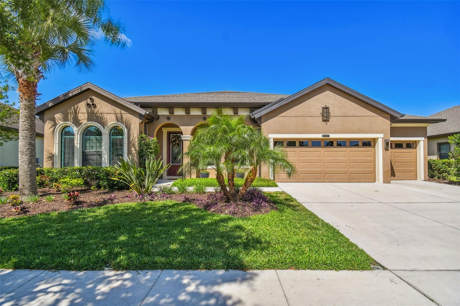 STUNNING, WEST BAY KEY LARGO - MEDITEREANEAN ELEVATION, SINGLE STORY MOVE IN ready POOL +SPA HOME on OVERSIZED homesite, over QUARTER OF AN ACRE! Floorplan features 4 BEDROOMS, THREE BATHS, HOME OFFICE, DINING ROOM and BONUS ROOM. As you approach the home you will notice the wide driveway, 3 car garage and the intricate details of the exterior of the home. Entering through the front door, you will be impressed with the 12 ft SOARING CEILINGS, 8ft DOORS, GRAND FOYER and CUSTOM LIGHT FIXTURES. Left of the foyer through the double glass French doors is the home office featuring upgraded scratch resistant waterproof vinyl flooring, currently being used as a bedroom. To the right of the foyer is the beautiful formal dining room, with DECORATIVE MOLDING, CUSTOM WALL MIRRORS, FRAMED WINDOWS, TREY CEILING with crown molding, chandelier and throughway to the kitchen. The kitchen features 42" cabinets, backsplash, granite counters, gourmet kitchen package with microwave wall oven combo, gas cooktop, dishwasher and refrigerator. Island features double sided cabinet storage, and custom pendent light fixtures. Open concept living, the kitchen opens to the GRAND ROOM and KITCHEN eat in area. Grand room features decorative built in ENTERTAINMENT UNIT, 16 ft glass sliders that open to the left bringing the outside in. The stunning covered & screened lanai is perfect for gathering with friends and neighbors around the pool. Salt water pool installed in 2018 with pebble tec finish, hot tub, with decorative accents and paved pool deck, with screen enclosure still leaving plenty of yard space for enjoying bon fires with friends. Spacious Owners' suite features trey ceiling with crown molding, accent wall and upgraded scratch resistant vinyl floors, two walk in closets and owner's bathroom retreat features his and her sinks, soaker tub with tile surroundings and upgraded listello tile, oversized walk-in shower and private water closet. To the right of the kitchen are 2 additional bedrooms, full bath and oversized laundry room. Further down from the grand room is the 4th bedroom, full bath with walk in shower, upgraded tile and decorative listello and access to the pool. The bonus room is a spacious retreat from the rest of the home with French doors to the lanai perfect for a game room and entertaining. Home has vinyl floors in all bedrooms & office & reclaimed water for irrigation. Connerton Community boasts an impressive resort-style pool & splash park. Play a pick-up game with friends & neighbors at one of the many sport courts including basketball, tennis & volleyball. Frequent the fitness center or walk outdoors along the nature trails. With a full event calendar, you’ll love gathering with new friends & neighbors for community events at the clubhouse & outdoor amphitheater.