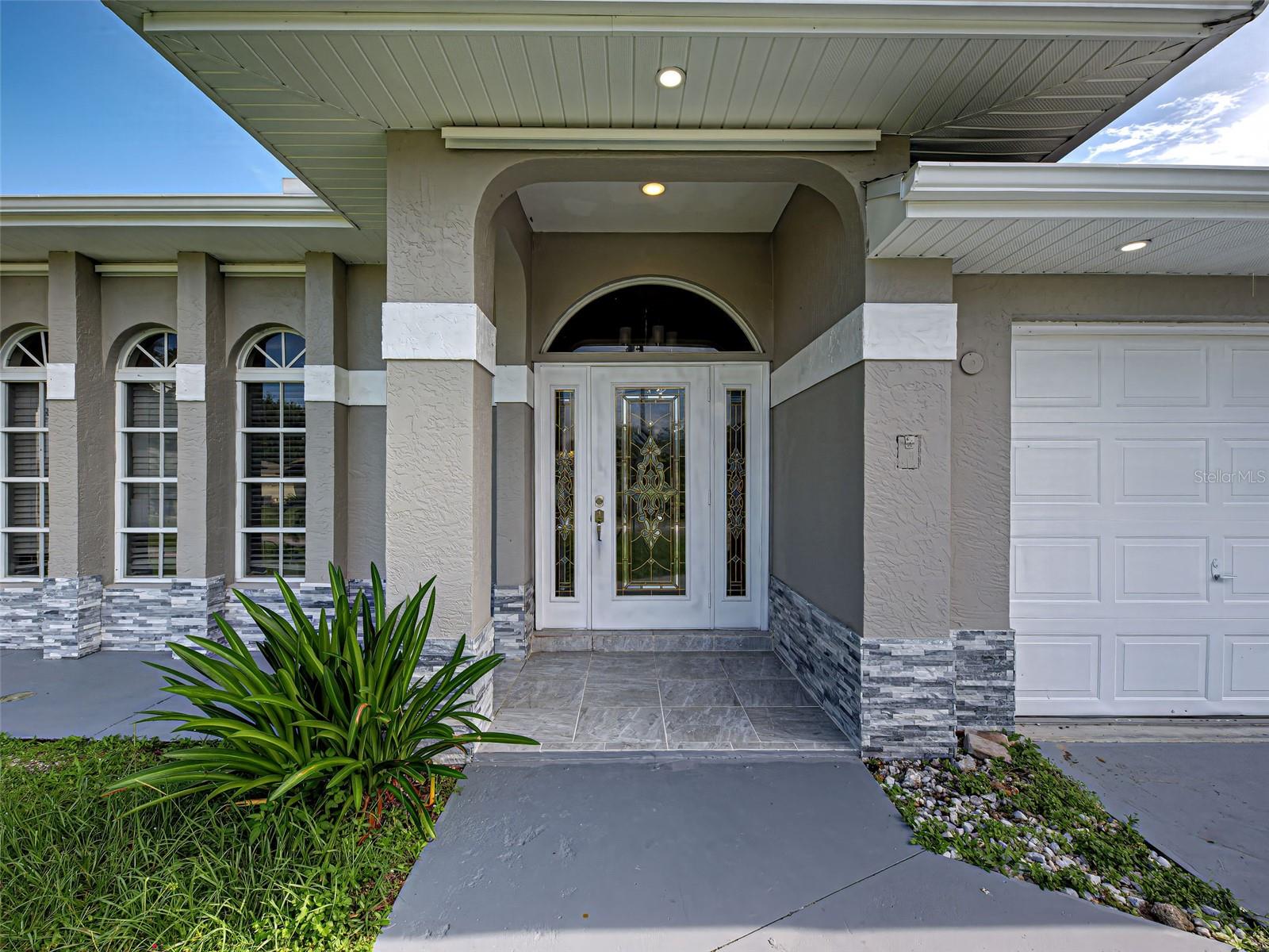 One or more photo(s) has been virtually staged. Experience the ultimate in luxury living with this completely remodeled home featuring your dream kitchen, abundant storage, and spacious bedrooms. Step outside to a stunning heated pool complete with a large sun shelf and splash pad, perfect for relaxation and entertainment. The oversized lanai offers ample space for both lounging and dining, with convenient access to a bathroom directly from the pool area. Enjoy seamless indoor-outdoor living with sliders from the living room, dining room, kitchen, and master bedroom that open to the lanai and pool. With a new roof and skylights, this home is bright and inviting, exuding warmth and love from the moment you enter. Rest easy knowing this property has never flooded or experienced water intrusion, even during hurricanes. The large yard is already fenced in for the safety of your pets. Must see!!