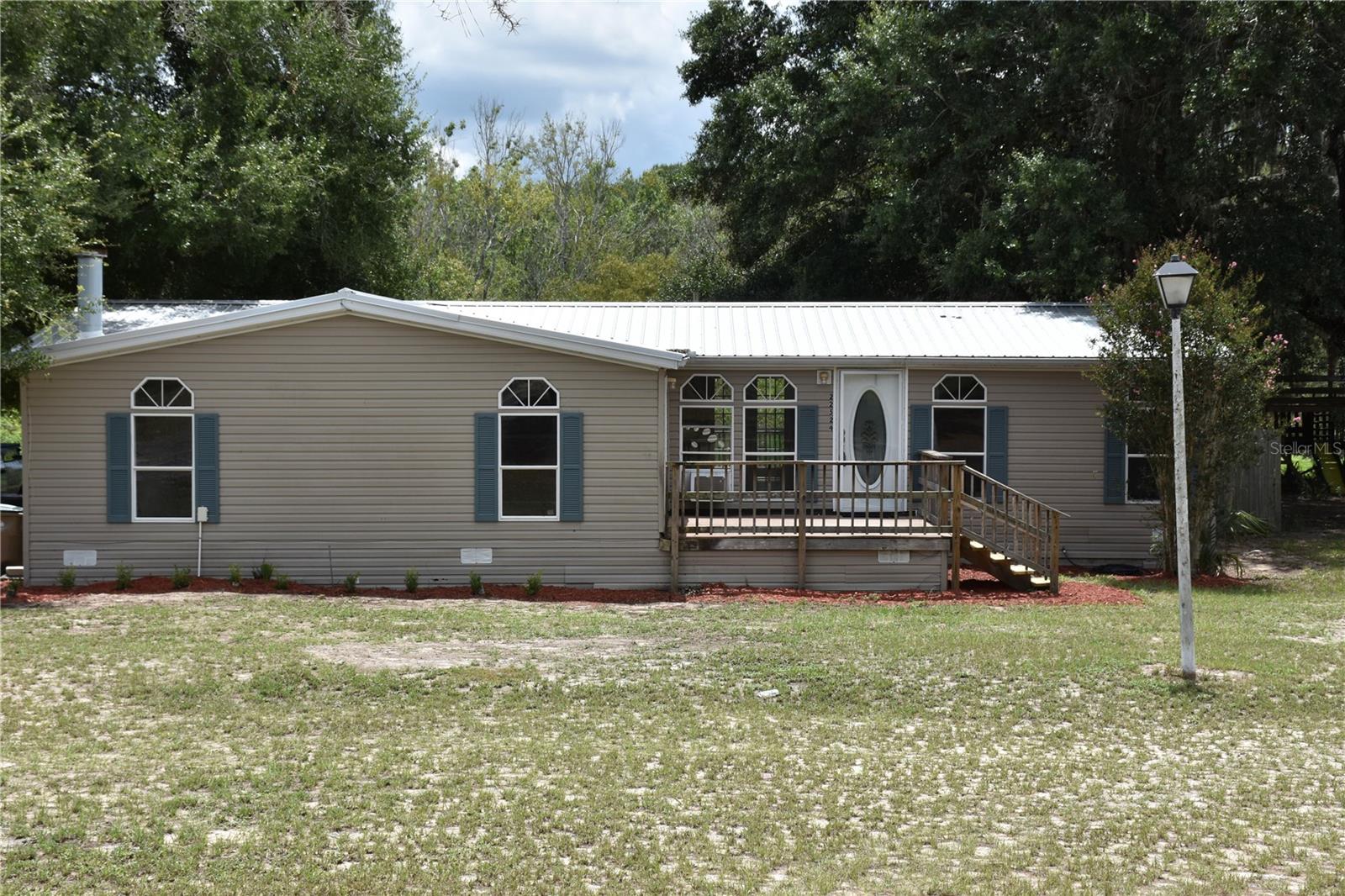 Come home and unwind in this fully remodeled 4-bedroom, 2-bath, 1,863 sq. ft. home with a durable metal roof. This triple-wide manufactured home is thoughtfully set back from the road, offering spacious front and rear yards. The split floor plan features fresh paint throughout, along with new laminate flooring in the family room, kitchen, dinette, and master suite. Enjoy the wood burning fireplace for easy of a quiet cozy evening.
Relax, grill, and enjoy the wildlife from the privacy of the rear deck with a peaceful view through the oak hammock. The 2-acre fenced pasture is perfect for livestock, or you can raise your own chickens in the existing coop — offering the space and setup for true country living. A separate 20x40 fenced area is ideal for a private garden and is ready for tilling. Additional amenities include a dog pen, a 12x24 storage shed, and a 10x28 storage unit.
The property’s natural surroundings are home to whitetail deer, wild turkeys, and the occasional otter.
Come and see all the possibilities this property holds!
