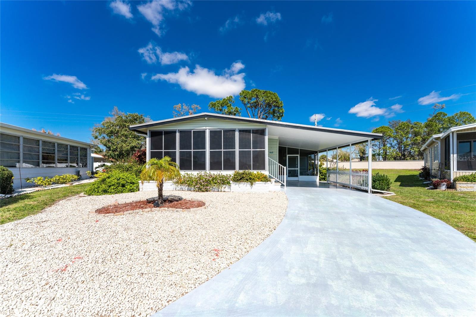 Discover the Vibrant Lifestyle in the 55+ Community of Alameda Isles! Bring your boat to this well-maintained 2 bedroom, 2 bath turnkey furnished manufactured home and enjoy the community marina, offering direct access to the Gulf of Mexico. A carport with screened lanai provides a warm welcome to step inside and explore everything this home has to offer. The great room is light and bright and opens to the dining room and kitchen and has sliding doors to access the screened lanai. White cabinets, tile backsplash, a reach-in pantry and breakfast bar complete the kitchen space. A built-in hutch with glass doors in the dining area will be the perfect spot to highlight family photos or your favorite art pieces. Vinyl plank flooring in the main living areas and tile in the bathrooms will make this home easy to maintain. The ensuite master bedroom has a beautifully updated master bath with dual sink vanity, tiled walk-in shower and walk-in closet. The guest bedroom features a walk-in closet and the guest bathroom has a nice granite topped vanity and tub/shower combo. The nice sized enclosed Florida room has phenomenal views of the pond through the large windows. Expand Your Outdoor Living with the screened lanai on the side of the home, complete with a utility closet, provides the perfect space for your grilling area and alfresco dining. Alameda Isles offers a wide array of amenities and a beautiful clubhouse, ensuring a fulfilling and enjoyable living experience. Dive into the heated swimming pool, relax in the therapeutic spa, or stay active in the exercise room. Outdoor activities include tennis, bocce, and shuffleboard courts, along with BBQ grills, picnic tables, and a putting green. Some favorite events are the monthly pancake breakfasts and Friday night bonfires. Boating enthusiasts can take advantage of the 59-slip marina and optional boat/RV storage (by lease, when available) for added convenience. This home and community have everything you need to start enjoying an active Florida lifestyle, contact us today for an appointment.