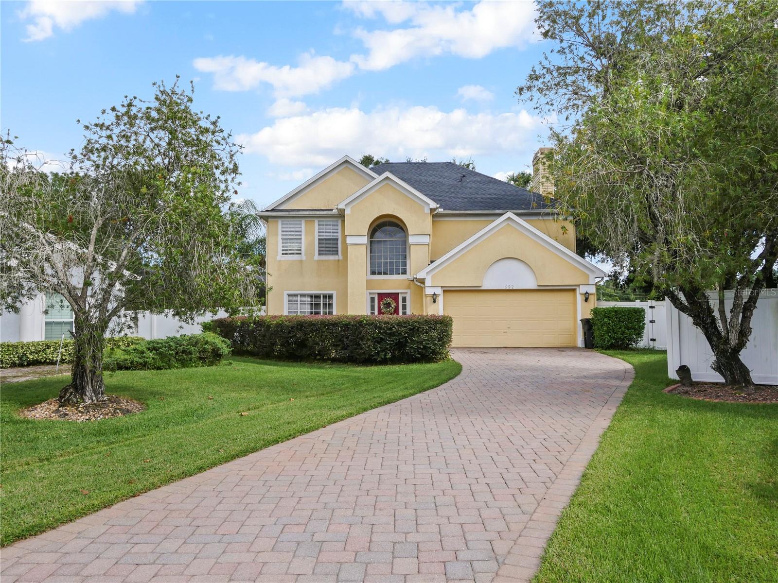 What a true gem in the desirable community of Osprey Landing in Lake Mary! This spacious two-story home features 4 bedrooms and 2.5 baths, situated on an oversized cul-de-sac lot with a long brick-paver driveway. Recent updates include a new roof (2022), new plumbing, fresh interior paint, laminate flooring throughout, ceramic tile in the bathrooms, quartz kitchen countertops, crisp white cabinetry, stainless steel appliances, and ceiling fans in every bedroom. Step inside to a grand foyer with soaring ceilings and natural light pouring through large windows, creating an open and airy feel. The dining room, kitchen, and family room all overlook the fenced backyard—perfect for gardening or outdoor play. The family room features a cozy wood-burning fireplace, while the breakfast nook opens onto an expansive 30’ x 13’ covered patio with brick flooring—an ideal space for entertaining and outdoor cookouts. From the patio, follow the walkway to your private screened tropical saltwater pool, an inviting retreat surrounded by lush greenery. Upstairs, you’ll find all four bedrooms, including the spacious primary suite tucked away at the end of the hallway for added privacy. Located within walking distance of Lake Mary High School and just minutes from shopping, dining, and major highways, this home offers both convenience and lifestyle in one perfect package.