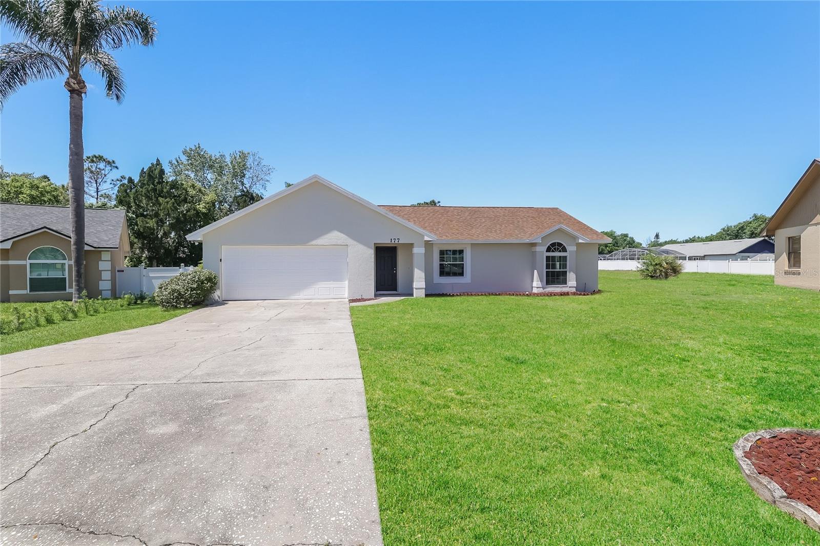 Bright and spacious 3-bedroom, 2-bath home featuring a split floor plan, tile and wood-look flooring, and a large living area with high ceilings. Kitchen offers ample cabinet space, breakfast nook, and easy access to dining area. Generously sized main bedroom includes an en-suite bathroom with double sinks. Enjoy the enclosed lanai overlooking the backyard. Conveniently located near shopping, dining, and major roadways. Easy to show!