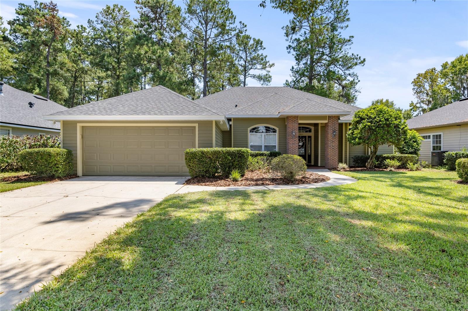 Looking for character and warmth over stark and modern? This Turkey Creek treasure delivers timeless craftsmanship with tall archways, regal wood cabinetry, charming wall cutouts, and crown molding, all beautifully updated with a new roof (2023), fresh interior and exterior paint, and new landscaping.
Your arrival is marked by two stately brick columns framing the front door. Inside, natural light floods through abundant windows, drawing your eyes straight ahead to the living area with elegant built-ins and fireplace. To your left, the formal dining room features a tray ceiling, while just beyond, the kitchen and breakfast nook form the heart of the home. The kitchen’s skylight and wraparound bar, along with the nook’s bay windows overlooking the backyard, make this space bright, airy, and perfect for cooking or casual dining.
Through an arched doorway past the dining room, the rest of the home unfolds: a laundry room with garage access, a second bedroom, a guest bath, and a third bedroom, all laid out for convenience, privacy, and flow.
At the opposite end of the home, the huge primary suite is a true sanctuary, overlooking the backyard and featuring its own private entrance to the patio. The primary bathroom is generously sized, comparable to one of the other bedrooms, and offers a walk-in shower, Jacuzzi-style tub, and wall-to-wall closet. With tray ceilings, abundant light, and direct backyard access, this suite combines luxury, function, and tranquility.
Throughout the home, original hardwood floors and ceramic tile add warmth and durability, while updates like the new roof, fresh paint, and landscaping ensure it’s move-in ready.
French doors from the main living space will lead you outside to a 37 feet x 10 feet covered lanai. The fully fenced yard offers plenty of space for pets, gardening, or quiet evenings under the trees. Living in Turkey Creek means enjoying a gated entrance, golf course, clubhouse, pool, tennis and pickleball courts, playground, and walking trails, all just minutes from Gainesville, Alachua, and I-75.
If you’re searching for a home with traditional elegance, character, and thoughtful design, this Turkey Creek gem is ready to welcome you home.