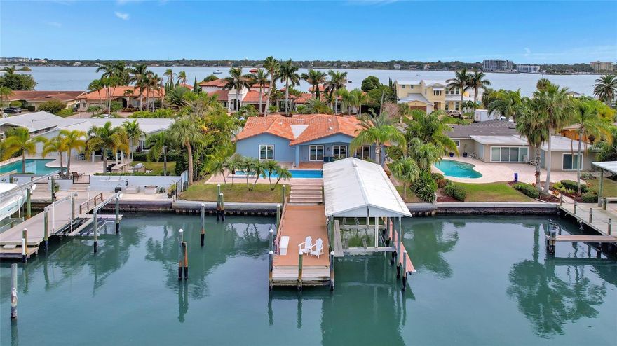 LOCATION! LOCATION! LOCATION! Welcome to 130 Windward Island, a stunning single-family residence located in the Island Estates on Clearwater Beach. This meticulously maintained 3-bed, 3-bath waterfront home boasts a spacious living area of 2,837 square feet. Step inside to discover a home that effortlessly blends elegance with practicality. The open floor plan seamlessly connects the kitchen and family room, creating a warm and inviting atmosphere. High ceilings and an abundance of natural light enhance the living space, making it both functional and pleasing. The kitchen is a culinary haven, featuring solid walnut cabinetry, a beautiful wet bar that is ideal for entertaining, an extra-large island and cooking features, a custom-designed coffee bar area, beautiful quartz countertops, an appliance garage with electrical outlets, and a walk-in pantry.  The gourmet kitchen features high-end Thermador appliances that are impressive to use. Additional upgrades include: in 2020, sellers added all new windows and sliding glass doors; a new AC unit on the south side; a new pool heater; and the kitchen, master bath, and library remodel featured above.  In 2021, the sellers added the 2nd AC unit on the north side, a new washer and dryer, all new Jandy SALT pool equipment with a remote, a new lower landing on the dock, piling wraps, and exterior paint, and an "Endless Pool" exercise system with a remote.  In 2022–23, the sellers completed all interior remodeling updates, including a new hurricane-rated garage door, new LED living room ceiling lights, and new stainless steel dock bolts.
The ideal split-plan layout features the primary bedroom on the main floor, which opens up to waterfront views overlooking the amazing pool. The master bathroom is not only a retreat; it has an oversized walk-in shower with one piece of floor-to-ceiling tile, dual sinks, and stone counters. The roof, a vital component, is only 3 years old, promising years of worry-free living and low insurance rates. Additional features include a substantial 25,000-pound boat lift, perfect for water enthusiasts, making it convenient to explore the beautiful waterways at your leisure. Entertain guests or relax in style with the heated Endless Pool Fastlane and spa, surrounded by a fenced backyard for privacy. This home offers a circular drive and a garage with a door opener, providing convenient access to the property. With an ideal location on Windward Island, there is easy access to Clearwater Beach's attractions, schools, and shopping centers.  Don't miss the opportunity to make this waterfront haven your home. Schedule a showing today and discover the epitome of coastal living at 130 Windward Island, Clearwater.