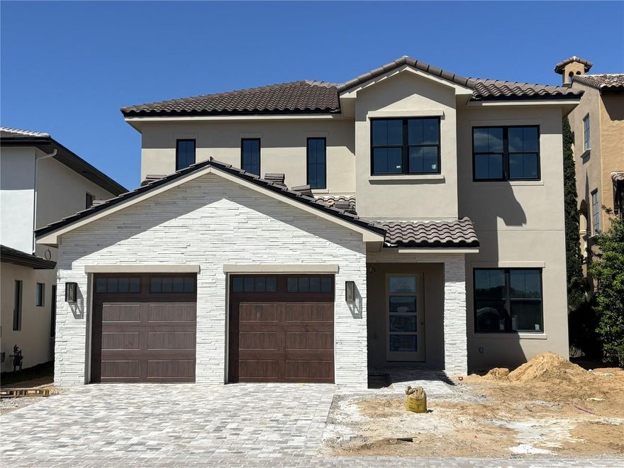 Under Construction. New construction luxury golf villa by Vogel Building Group, ideally positioned within the exclusive gates of Bella Collina. This thoughtfully designed two-story residence blends timeless European-inspired architecture with refined modern finishes, offering a refined yet comfortable lifestyle in one of Central Florida’s most sought-after private communities.

The welcoming façade showcases a harmonious mix of stone and smooth stucco, accented by a dramatic 10-foot entry door and designer exterior lighting. Inside, an open-concept layout creates effortless flow between the family room, dining area, and gourmet kitchen - ideal for both everyday living and elevated entertaining. The kitchen is beautifully appointed with custom cabinetry, premium countertops, statement lighting, and upscale plumbing fixtures, all curated with Vogel’s signature attention to detail.

The main level features a private guest suite with ensuite bath, while the second floor offers additional bedroom suites, a spacious game room, and a versatile loft with bar area - perfect for hosting or relaxing. Elegant flooring selections, curated lighting, and refined trim details elevate every space throughout the home.

Outdoor living is seamlessly integrated with a covered lanai, summer kitchen, and private pool, creating a true indoor-outdoor lifestyle. An upstairs deck further enhances the home’s livability, offering additional space to unwind and enjoy the surroundings.

Located in Bella Collina, residents enjoy access to world-class amenities including a Sir Nick Faldo-designed championship golf course, full-service spa, fitness center, tennis, pickleball, dining, and a vibrant social lifestyle - all just minutes from Orlando and major travel corridors.

A rare opportunity to own a brand-new, designer-curated Vogel home in a premier golf and lifestyle community. Schedule your private showing today. Developer will defer the $40,000 Sports Membership Deposit.