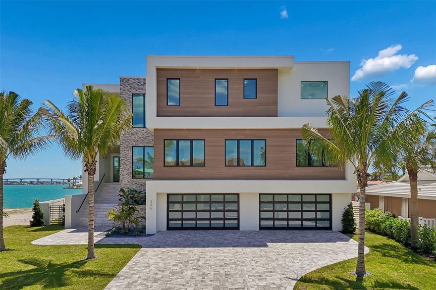 Discover the pinnacle of luxury, quality, and refinement in this brand-new custom California Coastal waterfront estate. Designed with exceptional craftsmanship and architectural sophistication, this residence embodies the highest standards of elevated coastal living. Soaring 25-foot ceilings create a striking sense of volume and light, while thoughtful conveniences include 42-foot-wide balconies, a commercial-grade elevator, dual laundry rooms, and an expansive 12-car garage. Constructed with uncompromising integrity, the home features full concrete construction, limestone cladding, deep-set pilings, and impact-rated casement and storefront windows. Inside, meticulously curated finishes showcase hand-selected natural stone, bespoke millwork, custom walnut cabinetry, and wide-plank European French oak flooring. The chef’s kitchen is appointed with Miele refrigeration, Wolf gas range, Wolf coffee system, Perlick wine column and Perlick clear ice maker, all complemented by honed Taj Mahal quartzite. A sleek linear gas fireplace and infinity glass railing add to the home’s refined aesthetic. Engineered for both luxury and longevity, the residence includes a protected deep-water dock, expanded seawall, and resort-style saltwater pool and spa—creating a private waterfront sanctuary. This newly built waterfront home—among the first offered to the public in over a decade in Belleair Beach—offers a rare opportunity along Florida’s Gulf Coast. The private residents-only beach lies just one block away, while world-class golf at Belleair Country Club and Pelican Golf Club is less than ten minutes from your door. Dimensions are estimates, buyer to verify.