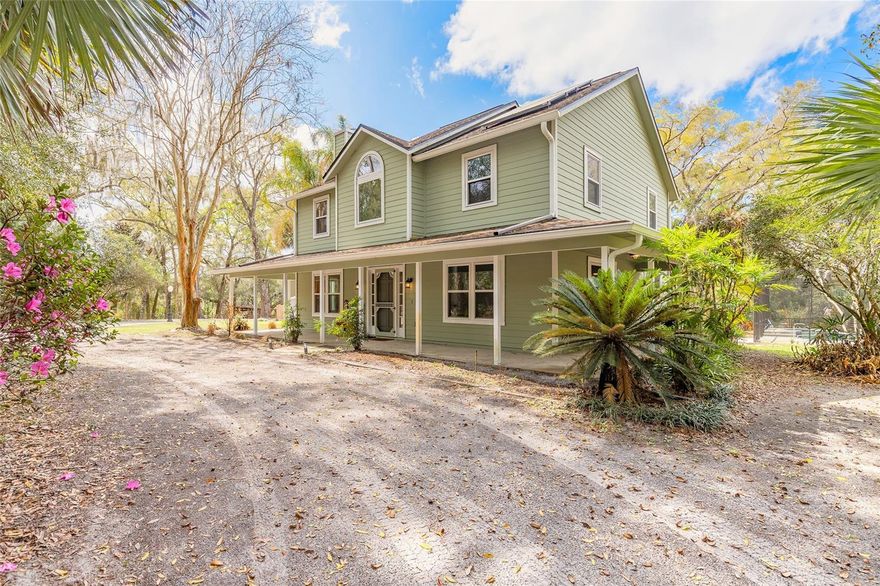 Tucked away on 2.83 fully fenced acres with a gated entry in NW DeLand’s Glenwood area, this agricultural (A-3) property offers privacy, functionality, and room to spread out. The 3-bedroom, 2.5-bath home with 3/4 wraparound covered porch features a formal dining room, dedicated parlor/flex space, screened-in pool overlooking open acreage, and an attached 2-car garage equipped with a mini-split A/C for added comfort and versatility. Designed to support a variety of uses, the property also includes a 20x20 metal garage/workshop, RV hookup, two chicken coops, garden area, large shed/barn structure, and mature landscaping throughout. The solar panel system is fully paid off, and the home is equipped with a generator connected to a propane tank, providing added reliability and peace of mind during storm season. The usable acreage offers open space along with natural privacy buffers suitable for agricultural, recreational, or hobby farm use. An adjacent 10.4-acre parcel at 2095 Stone Road, also zoned A-3, is available under a separate MLS listing and may be purchased together. Conveniently located with access to downtown DeLand, shopping, grocery stores, area parks, trails, and natural springs while maintaining a rural setting.