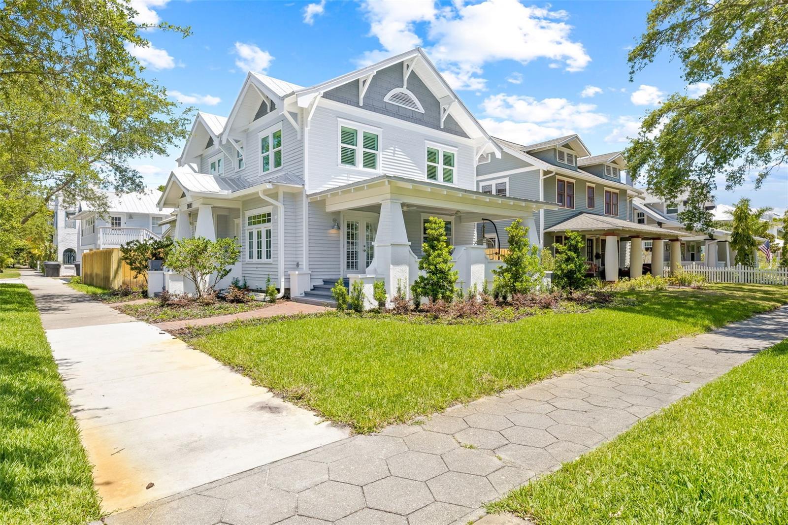 Blocks from Downtown St. Petersburg and its stunning waterfront park system, this beautiful fully-remodeled home in historic Old Northeast seamlessly blends modern convenience with classic charm. Everything has been renovated from top to bottom, inside and out! The deep front porch beckons evenings of ease with neighborly chats and the timeless architecture includes the clean lines of a newer metal roof for both style and durability. Detailed renovations include new impact windows, new bathrooms, new kitchen, reconfigured interiors and all the mechanical updates. Inside, the luminous wood floors exude timeless elegance, complemented by new plantation shutters offering privacy
and light control. Open, flowing spaces integrate 1920s design aesthetics with contemporary flair as the large living room opens to the porch and connects seamlessly to the main entry, dining room and kitchen. This balance of flow and historic ambiance creates a wonderful home for entertaining. The kitchen transforms any cook into a home chef with its expansive quartz counters, large island with seating and waterfall edge, Subzero refrigerator and wine fridge, and Wolf gas range. The main floor features a generous in-law suite / guest room or even primary bedroom with an optional private entrance. This downstairs space could be used may ways with its private living space, bedroom, kitchenette with a drawer refrigerator, full bathroom with a zero-threshold walk-in shower, and separate laundry hookups. Upstairs, discover an alternate spacious primary suite with a walk-in closet boasting custom cabinetry and an ensuite bathroom with a dual
vanity, step in shower, backlit mirror, and powered Toto toilet. Second upstairs bedroom with large windows is adjacent to the hall bath. The third upper bedroom, currently an office, includes a wet bar, beverage fridge, and access to the large second-floor deck. Second floor laundry closet has a new stack LG washer/dryer set. Ascend to the third-floor attic and find flex space for climate-controlled storage. The flow of the house and entertainment possibilities continue where the kitchen French doors open to a covered rear porch which steps down to a new paver patio. Entire yard has a new privacy fence which can accommodate a pool with some reconfiguration of the ADU entry. The oversized one-car garage stores your vehicle plus bikes, golf cart, kayaks or other recreational toys. More off-street parking is located behind the garage via the alley. A storage room attached to the garage could serve as an ideal workout room or home studio. Above the garage, a full accessory dwelling unit awaits, featuring an open living/dining/kitchen space, full bathroom, spacious bedroom, and in-unit stack washer/dryer. The total square footage includes the house and ADU but not the walk-up attic. The ADU is not included in the
bed/bath count of the listing. In case of power interruptions, the main home is backed by an automatic new Generac whole house generator. This 1925 home delivers the best of the classic Old Northeast Neighborhood in an amazing location and modern amenities.
Schedule your private showing today!