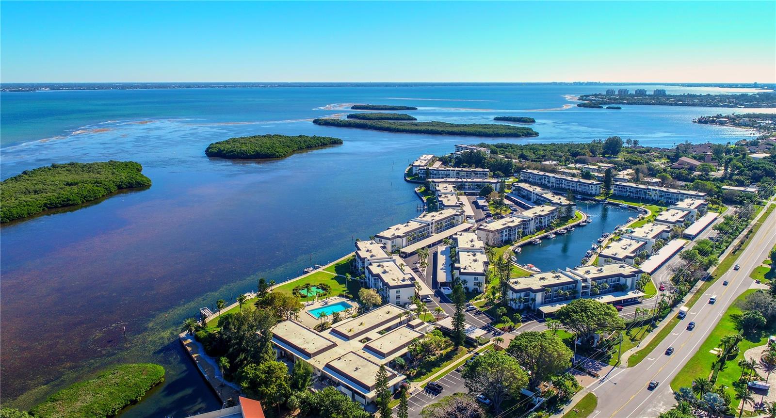 New Price!!! Now $385,000.Motivated Sellers!
Come experience quintessential Coastal Living in the dynamic community of Longboat Harbour located on beautiful Longboat Key. Note: NO Storm Damage! Imagine having your coffee while watching the sunrise from your enclosed lanai in the morning overlooking the water leading to Sarasota Bay, and later in the day, enjoying a private beach area on the Gulf of America with stunningly beautiful sunsets over a glass of wine and cheese. This is the lifestyle everyone dreams of! This convenient ground-floor condo features an updated kitchen and bathroom, new carpet , fresh paint and new vertical blinds in the lanai area. It also includes impact-resistant rated windows throughout and on sliders in the lanai. The unit is offered furnished (excluding bed). This resort-like community has an onsite manager, a wide range of recreational activities including four Heated Pools, Pickleball, Tennis, Shuffleboard, Mini-golf, Biking and a Kayak launch. Other amenities include a well-equipped fitness center with private locker rooms and saunas, a beautifully renovated recreation room with dance floor and kitchen for your social gatherings, billiards, art room, and wonderful fishing pier. Keep your social calendar packed with the weekly workshops, clay classes, Book Buddy Club, Library and clubs. The community is boater friendly with boat slips that will accommodate a sail or power boat up to 34ft for as low as $425 annually including water and electricity hookup, on a first come basis. Be sure to check out the community beach pavilion across Gulf of Mexico Drive only a short stroll away. It includes private deeded beach access, cabanas, indoor hot showers, restrooms, dressing area, beach chairs and equipment storage. Everyday feels like a luxury retreat so claim your piece of Longboat Key paradise today!