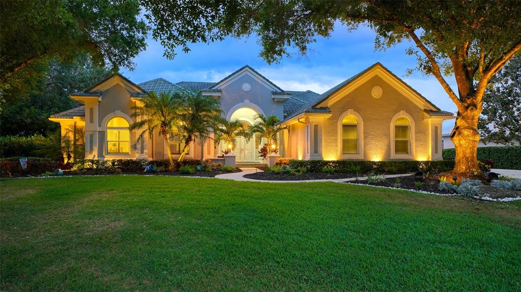 Lakefront home! Great curb appeal on this half-acre homesite, four large bedrooms, three-and-a-half baths, den/library plus bonus room! From the moment you enter the double glass doors, you will be amazed at the view. Great home to entertain with a large built-in bar in living/dining area, vaulted ceilings and decorative beams in many rooms and lots of storage. Den/library with cabinetry makes the perfect home office. Master retreat has unbelievable wall cabinets, plantation shutters, walk-in closet and custom shelving. Updated master bath with walk-in shower, dual sinks, hot water tank and plenty of cabinetry. Your gourmet kitchen has top-of-the-line appliances with Miele dishwasher, Sub-Zero refrigerator, Wolf gas cooktop and microwave. Beautiful light cabinets, farmer sink and the expansive quartz countertop will delight any cook. Bonus room has separate entry and could become fifth bedroom or excellent office or mother-in-law suite. Family room boasts gas fireplace and TV. Home has complete AV system and included for your indoor/outdoor entertaining. Newer hurricane windows provide efficiency for better AC/heat. Enjoy the expansive pool area with travertine flooring, large heated pool and spa, outdoor kitchen, 12-foot expansion on pool cage with clear view screening, AquaLink system for pool, deluxe lighting and more! Complete area for "garden center" with outdoor cabinetry. Oversized three-car side-entry garage with extra drive space. Plenty of storage in garage too. Laurel Oak Estates has 407 homes on 813 acres in the guard-gated community. Membership to the country club is optional for social, 12 Har-Tru tennis courts, pickleball courts, 2 18-hole championship golf courses and reciprocal to Bird Key Yacht Club. Live the lifestyle in your lakefront home!