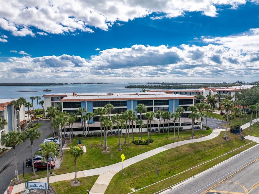 AWESOME WATERFRONT VIEW! Enjoy a breathtaking view of Lemon Bay and the Intercoastal waterway from your 19' long Florida Room   and Huge Open Sundeck.  French doors from the primary bedroom make it easy to wake up to an awesome sunrise every day! Watch dolphins, manatees and boaters go by as you enjoy the huge open deck.  Turnkey renovated 2 bedroom/2 full bath condo with a Fireplace! Just bring your suitcase!  Beautiful renovated kitchen has shaker cabinets to the ceiling, stainless steel appliances, recessed lighting, quartz countertops, Pergo luxury vinyl flooring throughout except entrance and baths.  Bathrooms have been renovated with tiled glass showers with one with a bench and rain shower head, condo has been newly painted with crown molding and upgraded doors, plantation shutters in kitchen and guest bedroom with drapery in the Florida Room. Hurricane windows in kitchen and guest bedroom make condo soundproof. Special features such as built in shelving in dinning room with breakfast bar and custom shelving in the primary bedroom closet make this condo extraordinary.  New Air Conditioner and Hot Water Tank.  Association has passed the State Mandated Milestone Structural Inspection with No Repairs Needed and established required reserves. Condo amenities include elevator, covered garage parking, bicycle/kayak/SUP storage, storage unit for beach or fishing supplies, guest parking, two pools with a heat/cool system making them refreshing all year long, small dock for fishing, gas grill areas with one conveniently located outside the building, a kayak area to launch onsite, Clubhouse/Library with fun social activities and an on-site Rental Office available. Enjoy a short 1/2 mile walk from your condo home on a well maintained sidewalk to beautiful Englewood Beach with many restaurants on popular Manasota Key with two offering free shuttles from the condo! For boaters, there are 60 privately owned docks in the Sandpiper Key Yacht Club just across the road that provides direct access to Lemon Bay and the Intracoastal Waterway and even the Gulf. Normally there is a dock or two available to purchase.  Come enjoy the Florida lifestyle!
