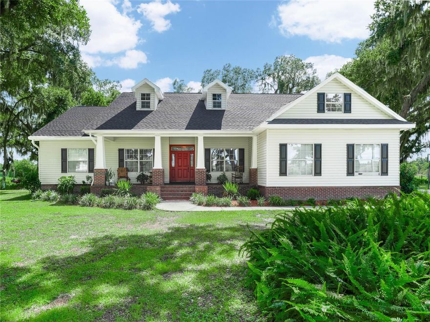 Nestled on a sprawling approximately 14.49-acre plot, this captivating house offers a peaceful and private retreat. The home features four bedrooms and three bathrooms, encompassing approximately 2,901 square feet of thoughtfully designed living space. BRAND NEW ROOF 4/2025. The majestic oaks lining the entrance create a charming and inviting atmosphere. Carefully designed with 6 courses of block and block foam  filled walls. The window and sliding glass doors are double paned, the garage door insulated. Inside, the home boasts a double foyer that opens to the formal dining room and living room, featuring soaring ceilings, decorative niches, and crown molding. The private office, with its large window, provides an ideal setting for a home workspace. The kitchen showcases Kraftmaid cabinetry, black galaxy granite countertops, and brand-new appliances. The separate dinette area offers a private entry to the lanai through French doors, creating a serene and inviting space. The expansive family room, with its wood-burning fireplace, provides ample room for family gatherings and relaxation. The primary bedroom, a generously sized suite, features a private sitting area and French doors leading to a private entry to the pool area.The primary bathroom boasts a decorative tile shower, luxury vinyl plank floors, a soaking tub, double sinks, double walk-in closets, and a separate water closet. The inviting lanai overlooks the lush pasture, offering a calming environment. The property also boasts an impressive 1,300 feet of creek, 600' walk from creek with teeming with fish, and a 50-by-95-foot, 6-horse stall barn, equipped with automatic water and 100-amp service, allowing for future loft expansion and 12 x 12 tack/tool room. Horse lovers will love white vinyl fenced riding arena with round pen. The property also features an oversized 2.5-car side-entry garage and ample parking on the long concrete driveway.